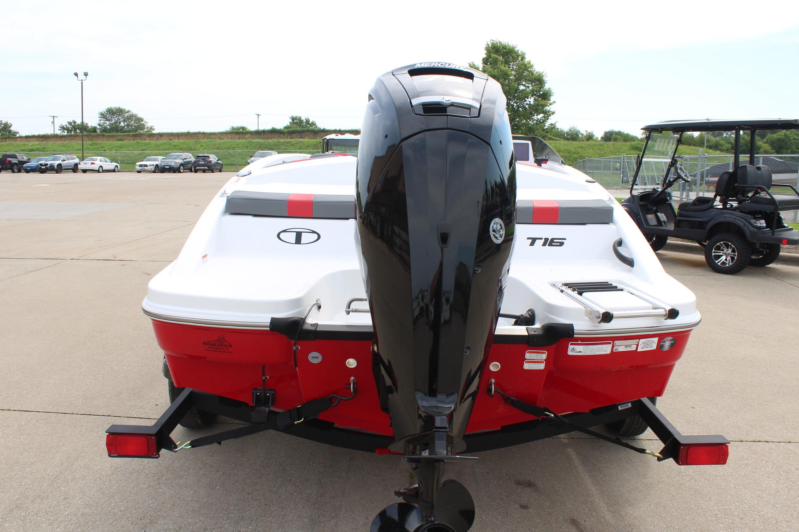 2026 Tahoe T16 boat with outboard motor, parked on a trailer in a lot.