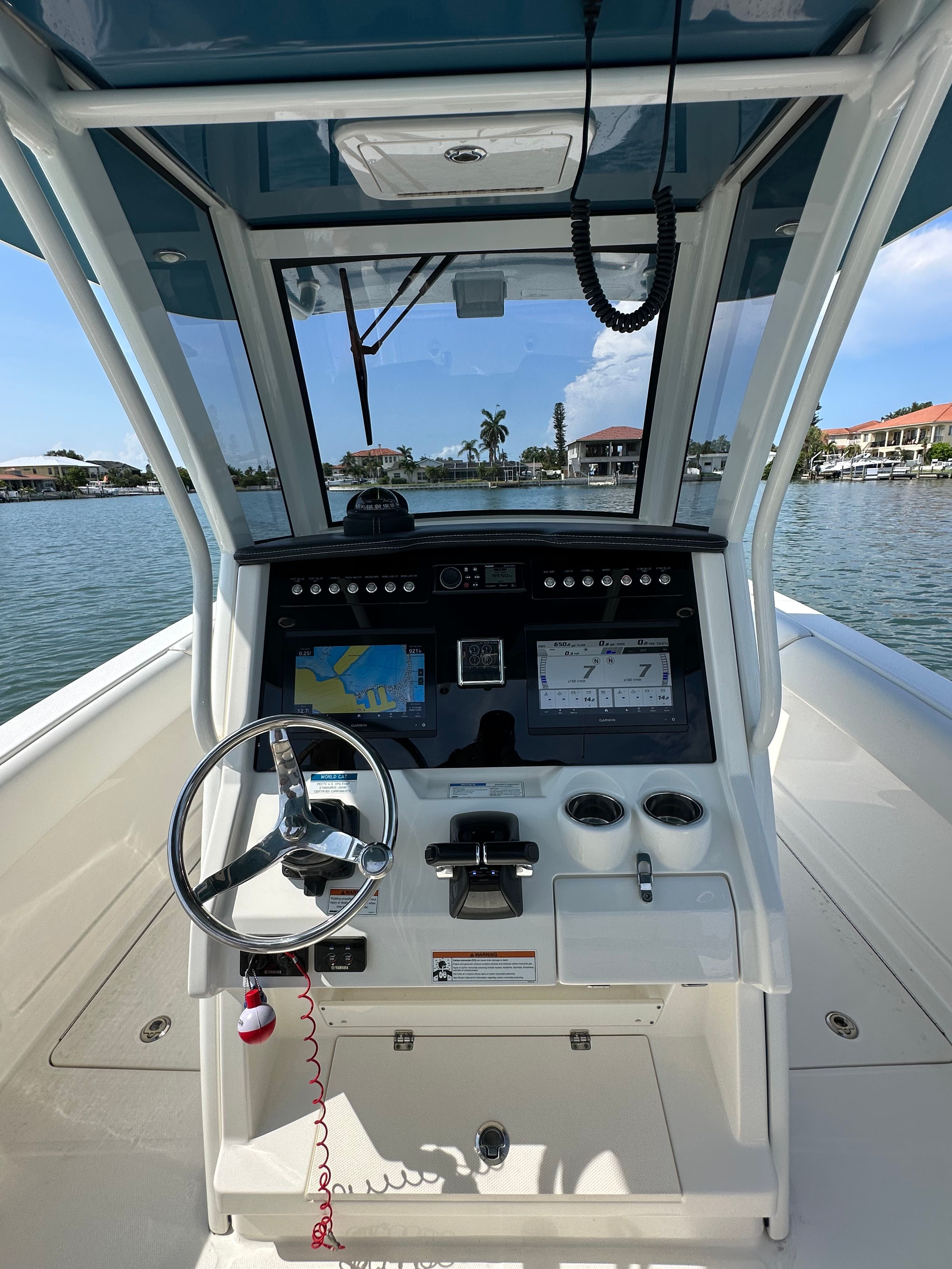 Helm of a 2020 World Cat 280 CC-X with steering wheel and navigation systems.