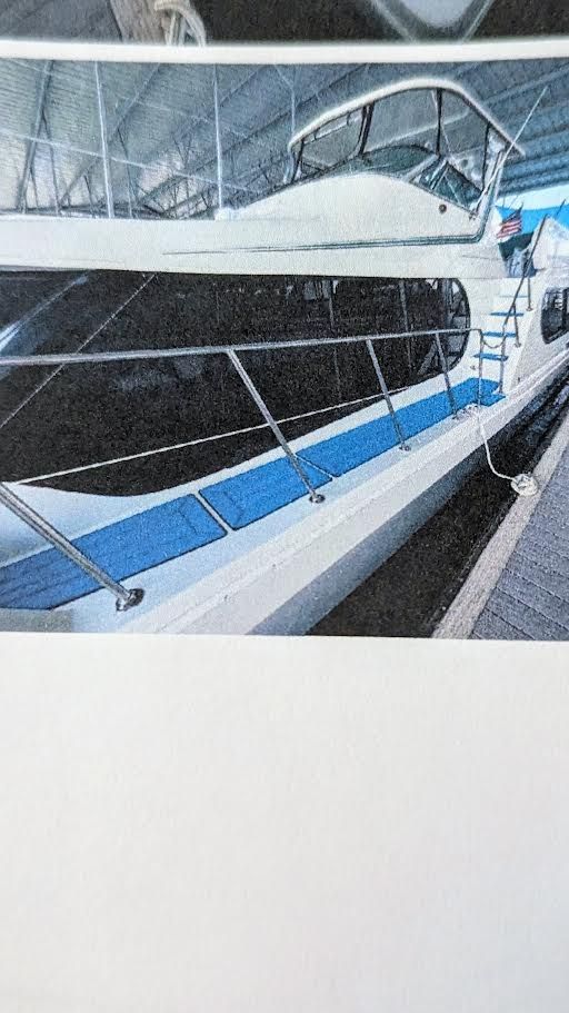 1996 Blue Water motor yacht docked, side view.