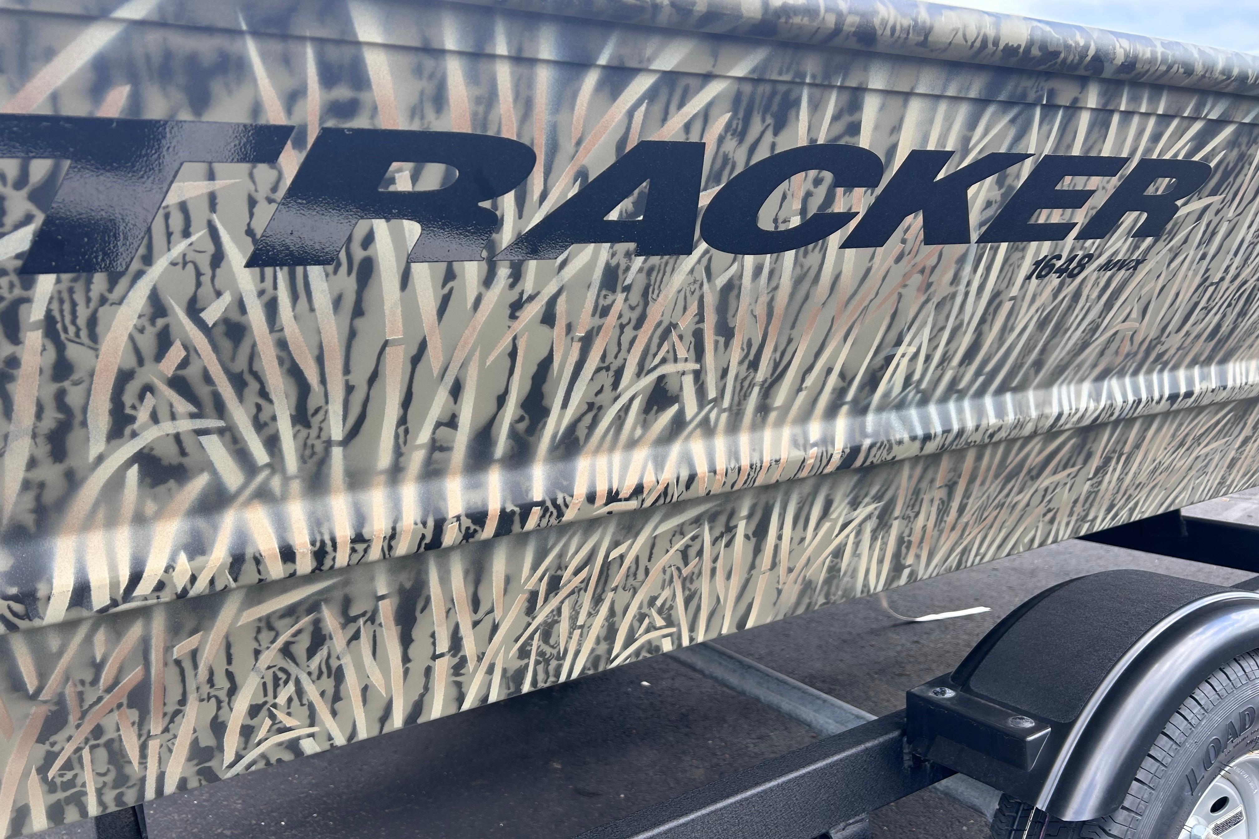 2026 Tracker Grizzly 1648 Utility boat with camouflage design on trailer.