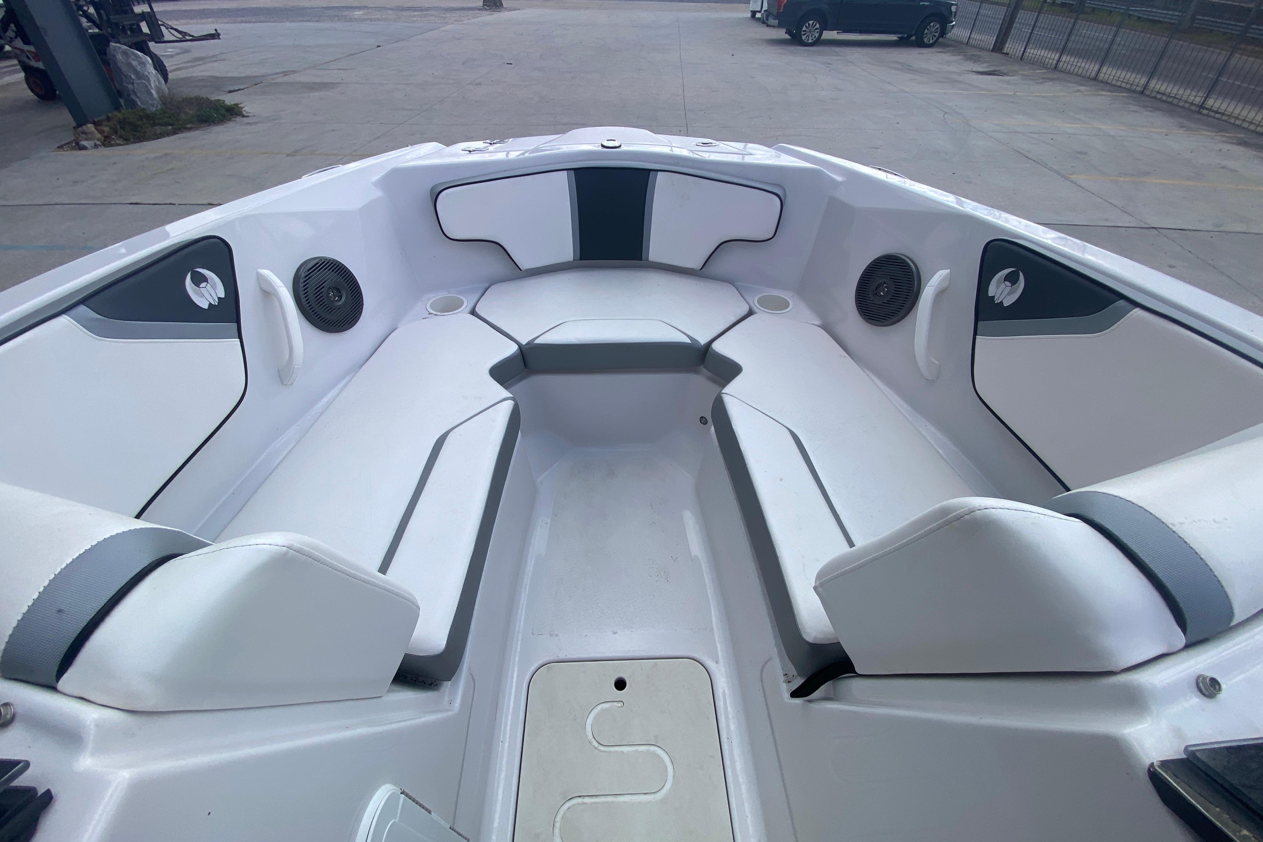 2018 Scarab 215 G boat interior with white seating and speakers.