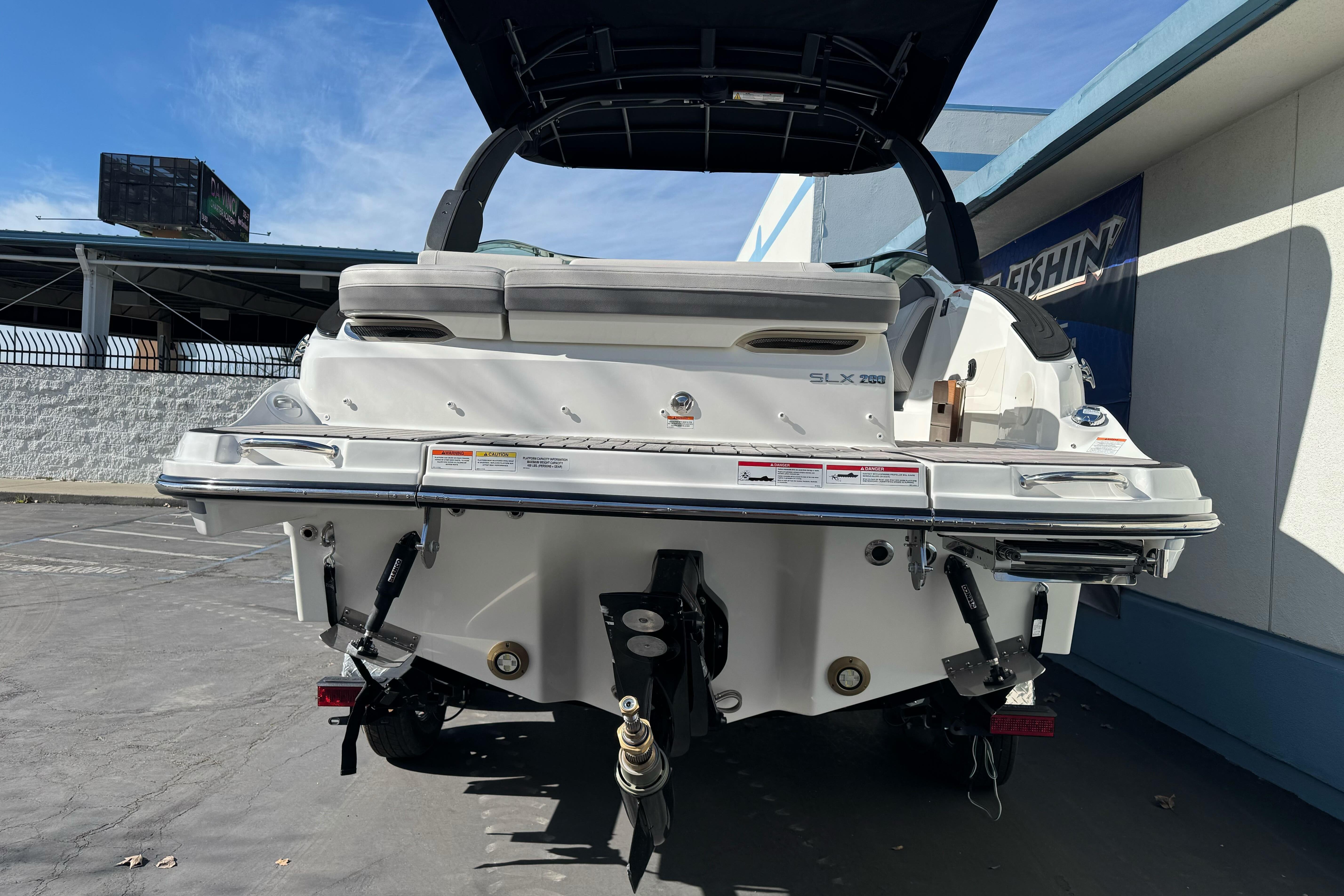 2026 Sea Ray SLX 260 boat rear view in a parking lot.