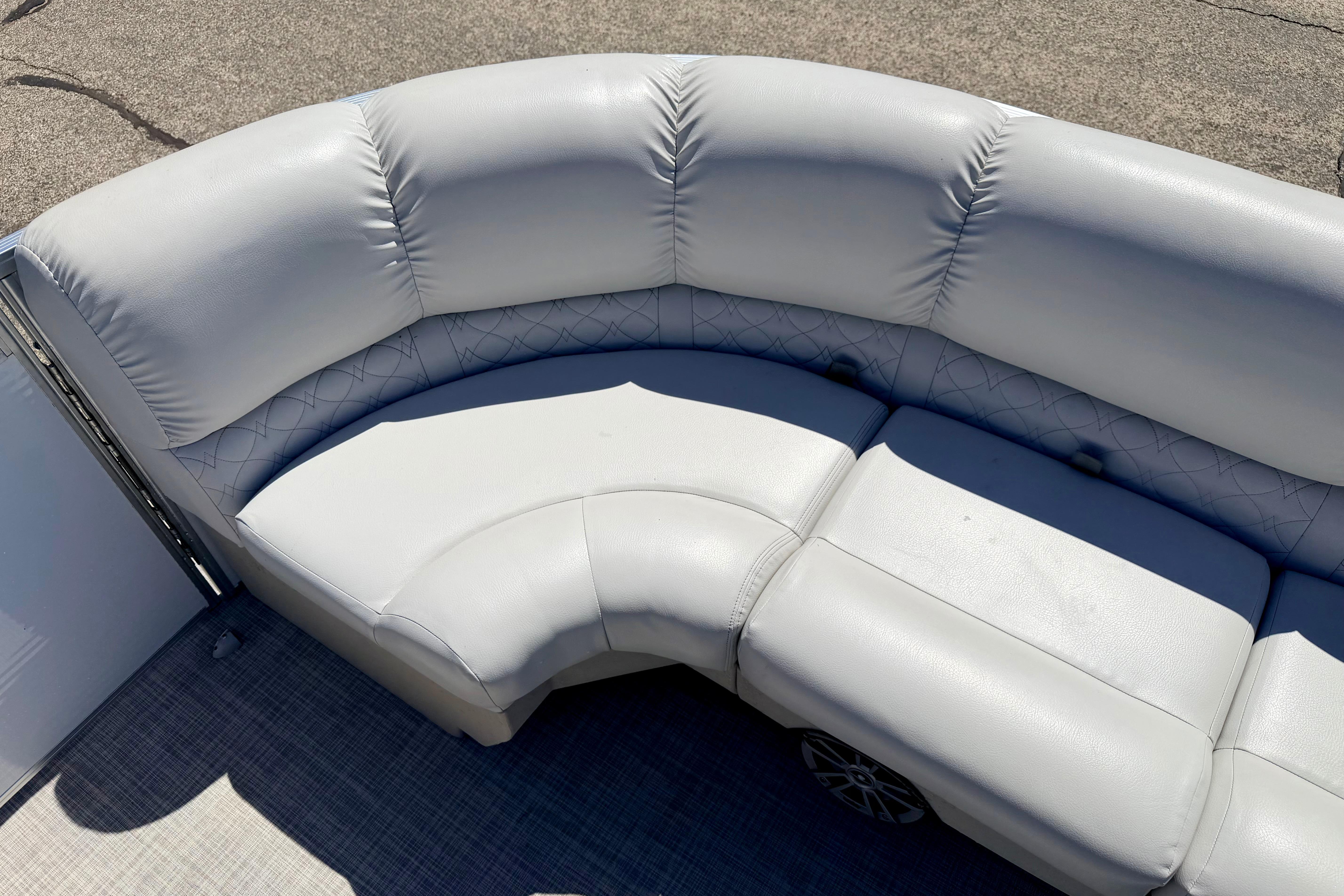 2019 Crestliner 240 Rally DX CW boat with plush, curved seating in light gray upholstery.