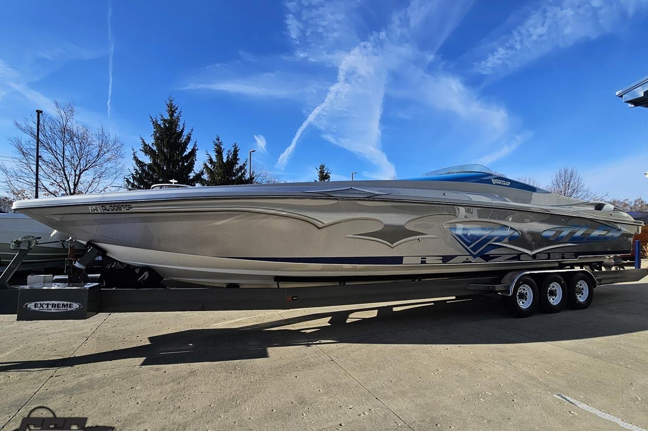 2007 Hustler 41 Razor speedboat on trailer under clear blue sky.