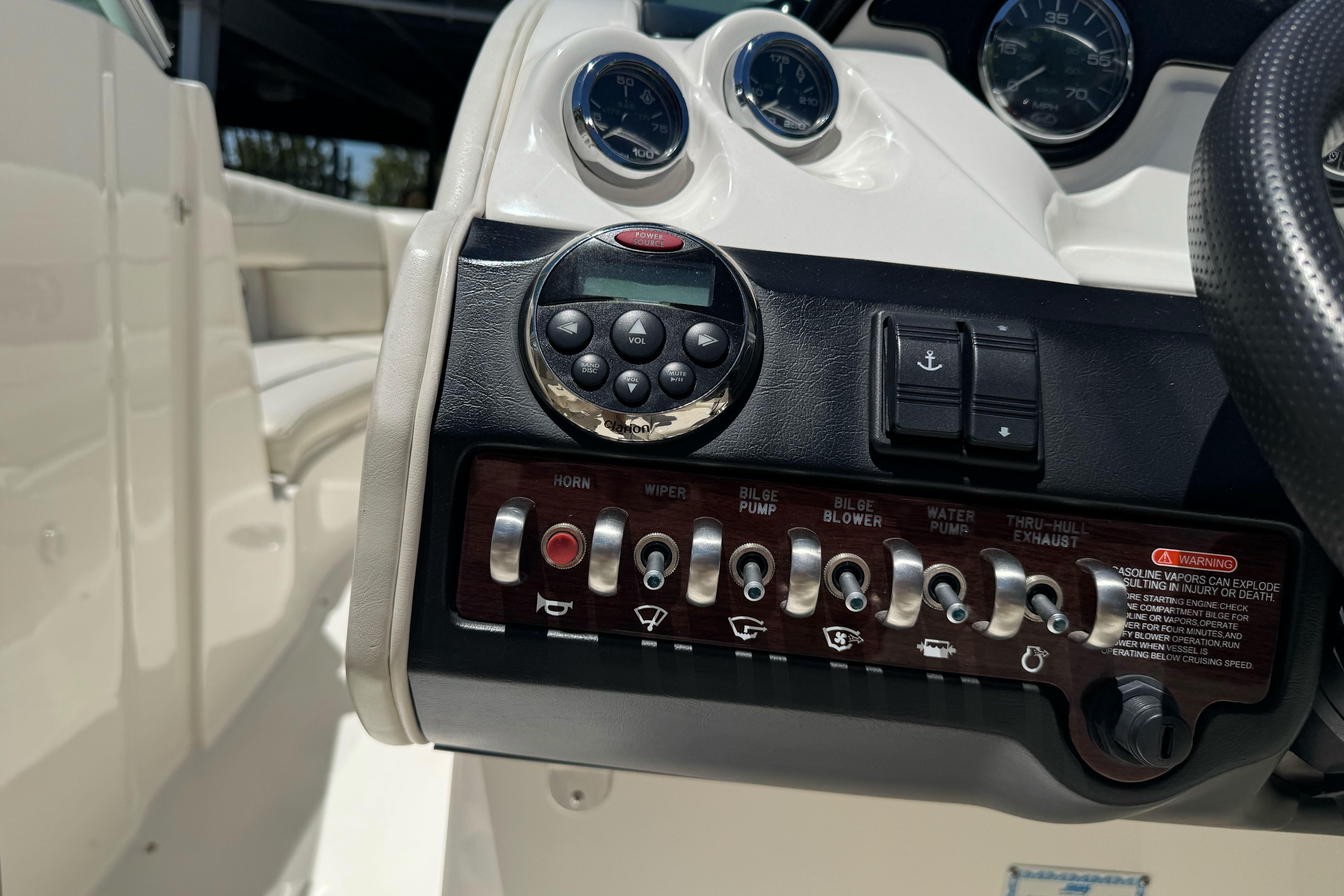 Control panel of a 2007 Sea Ray SLX 250 boat with various switches and gauges.