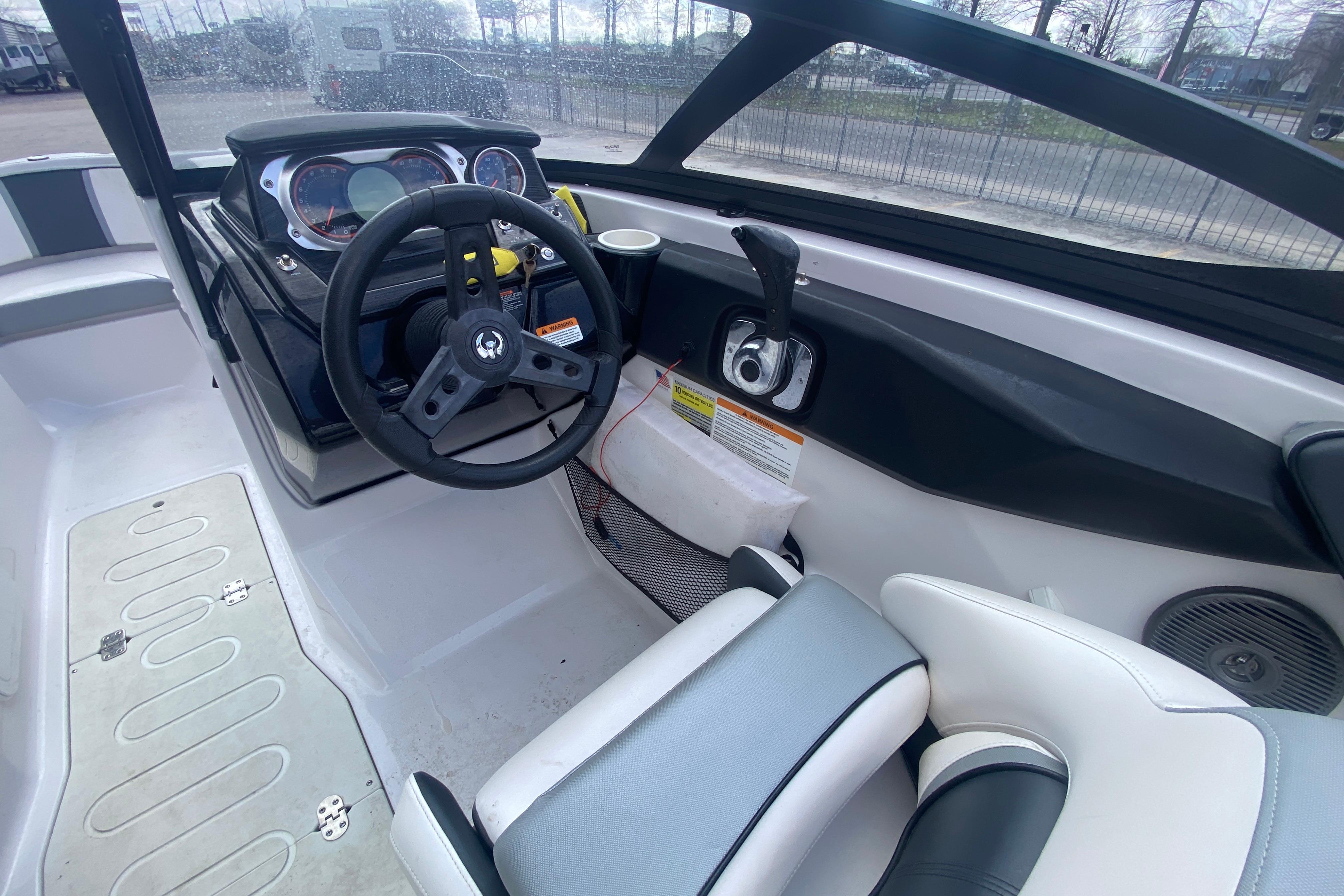 2018 Scarab 215 G boat interior with steering wheel and dashboard controls.