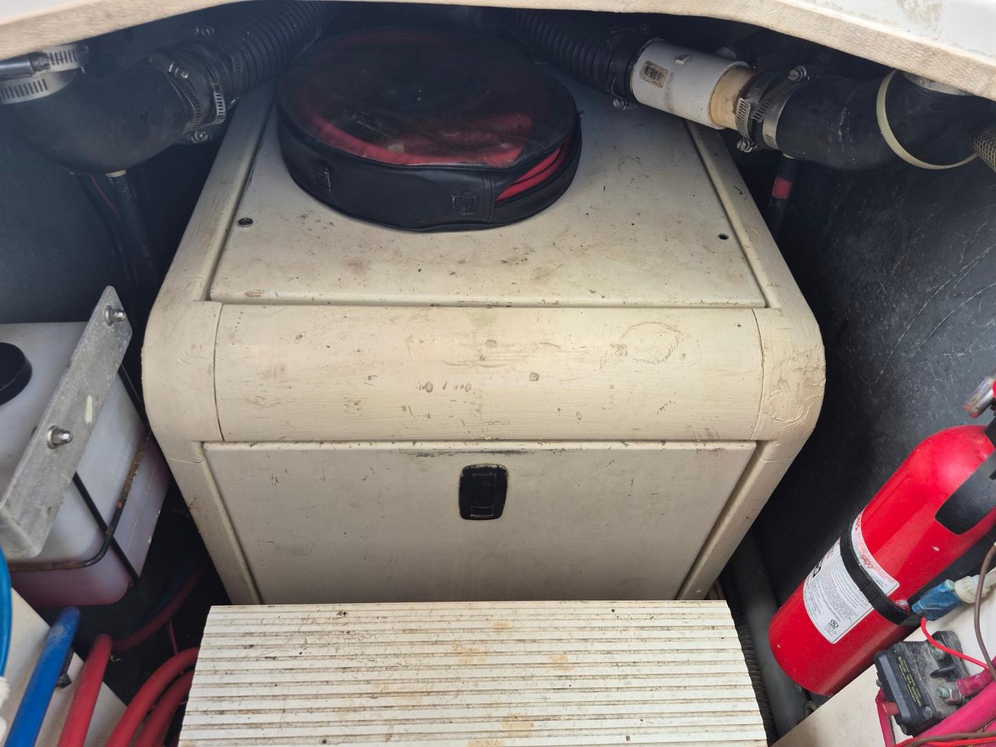 Engine compartment of 2002 Silverton 38 Convertible with fire extinguisher and equipment.