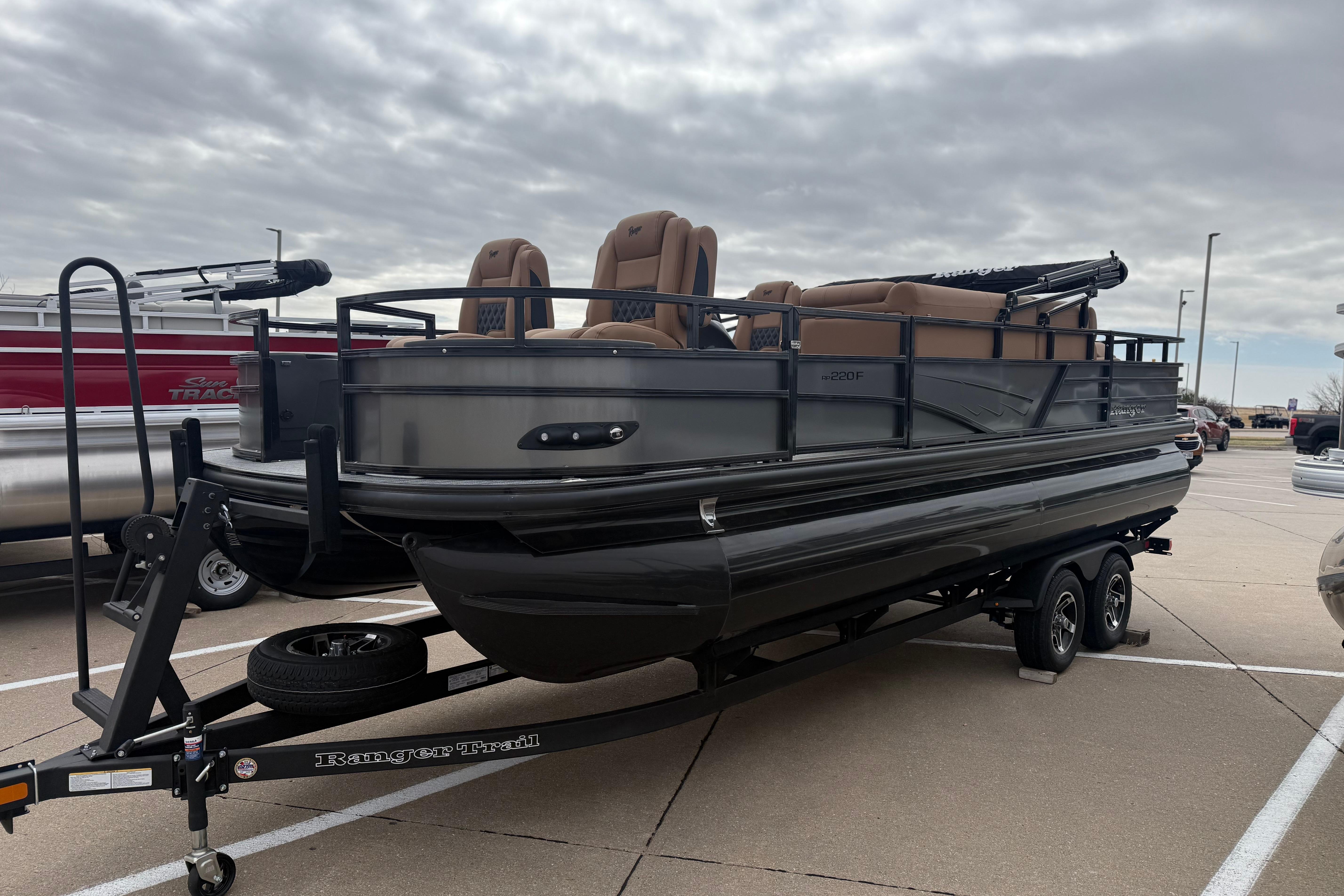 2026 Ranger 220F pontoon boat on trailer in parking lot.