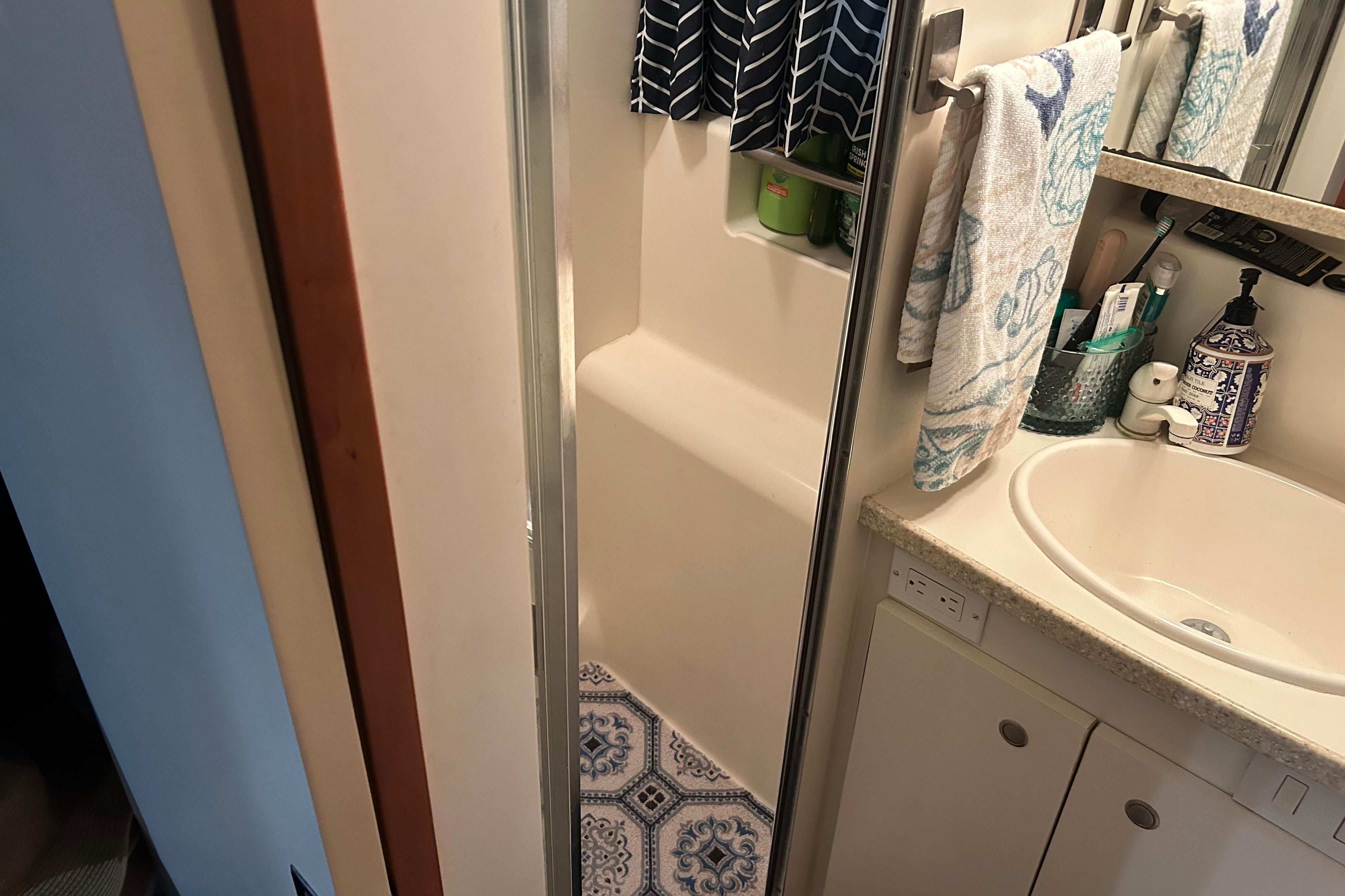 Bathroom interior of 1999 Silverton 352 Motor Yacht with sink and shower area.
