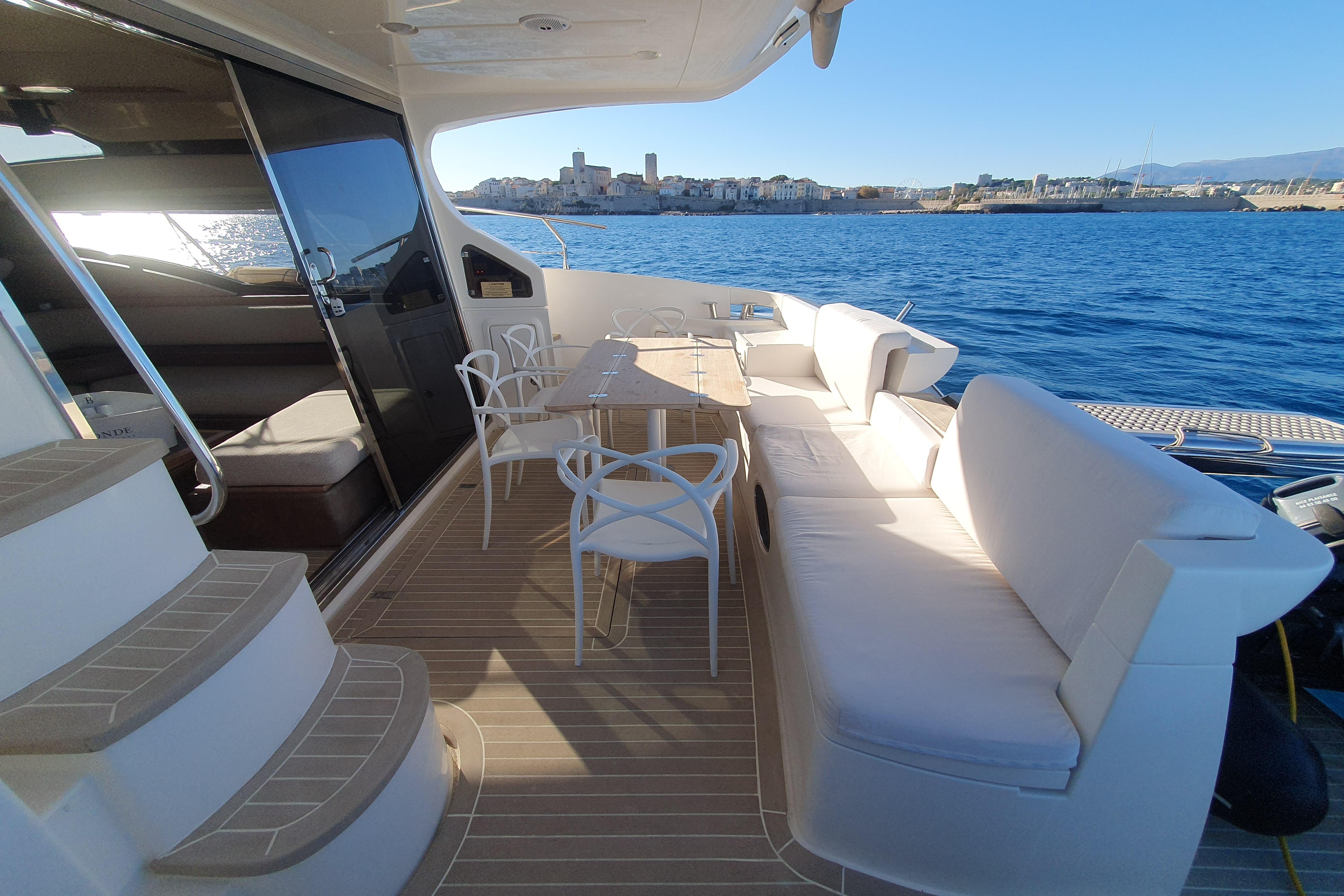Luxurious 2007 Azimut 47 yacht deck with seating, table, and ocean view.