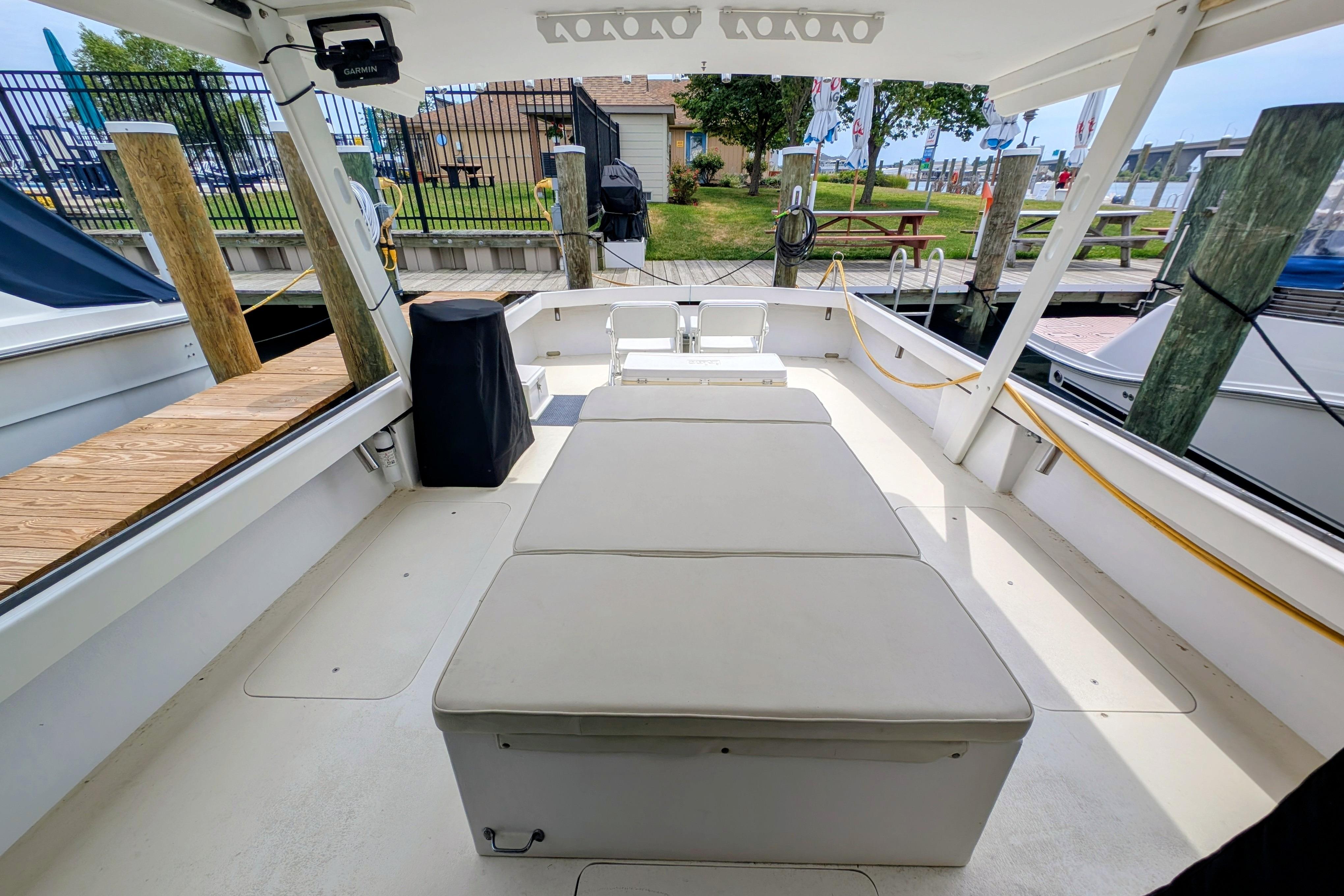 Spacious deck of a 1998 Markley 46 boat docked at a marina.