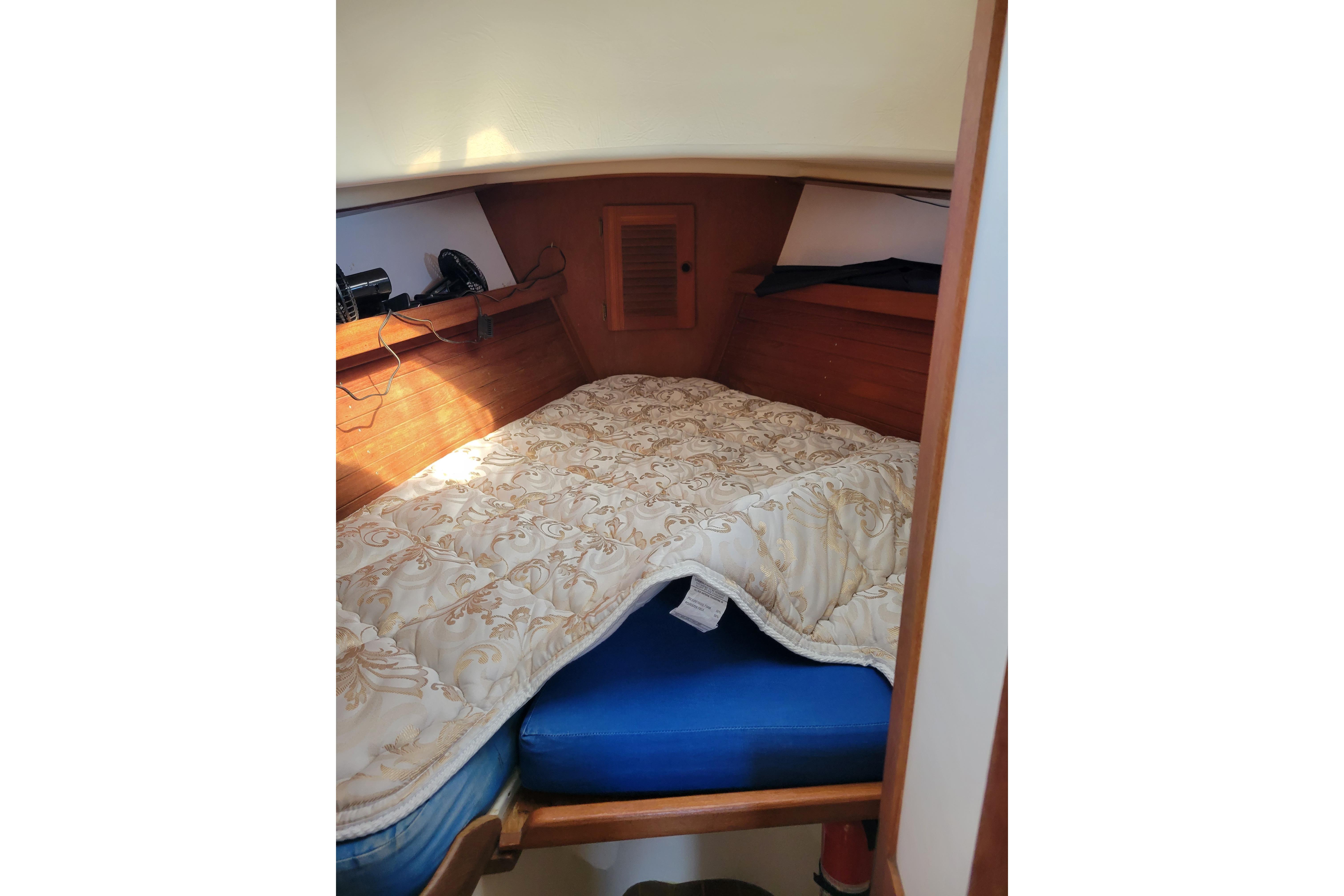 Cozy cabin interior of 1981 Sea Sprite 34 sailboat with comfortable bedding.