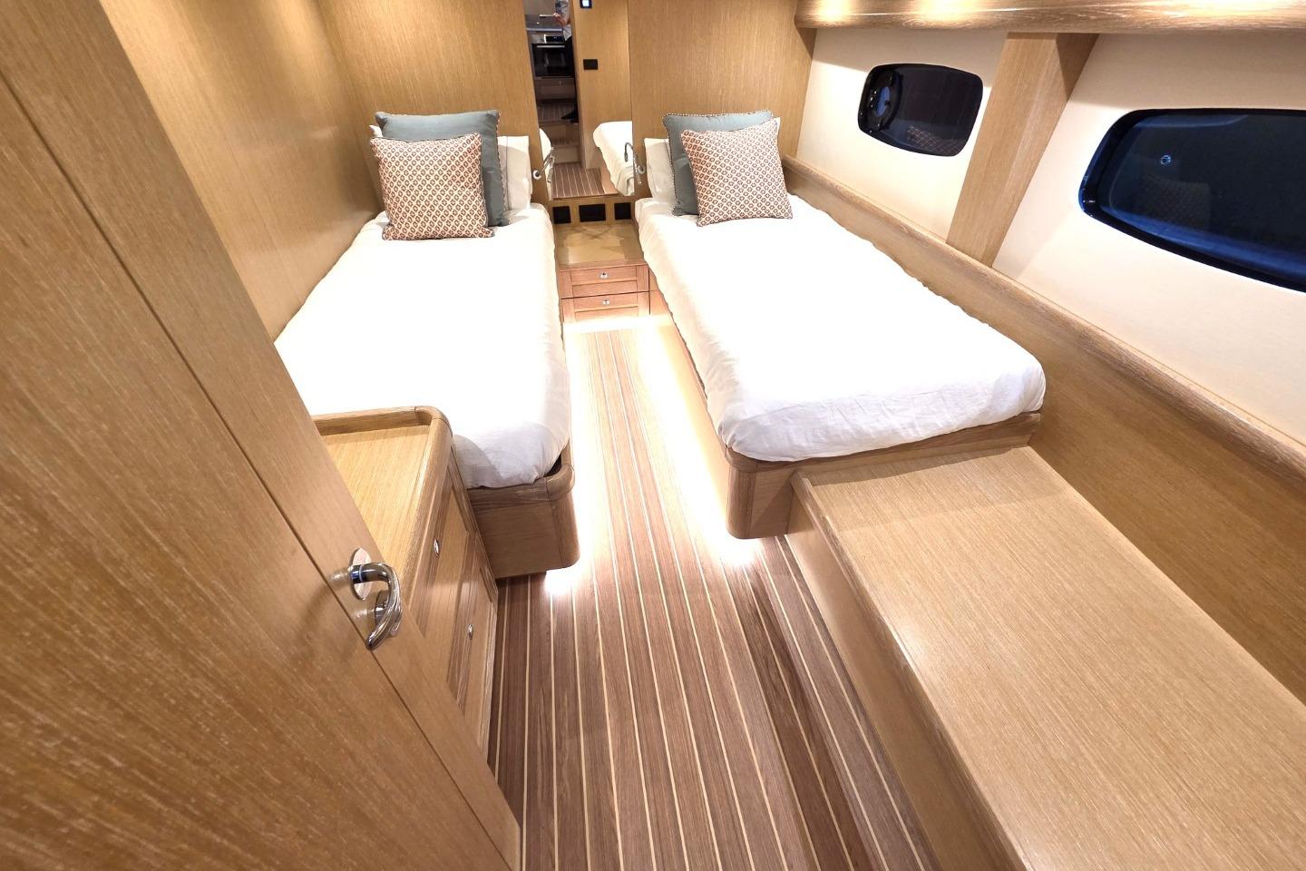 Luxurious 2026 Sasga Yachts Menorquin 48 cabin with twin beds and elegant wood finish.
