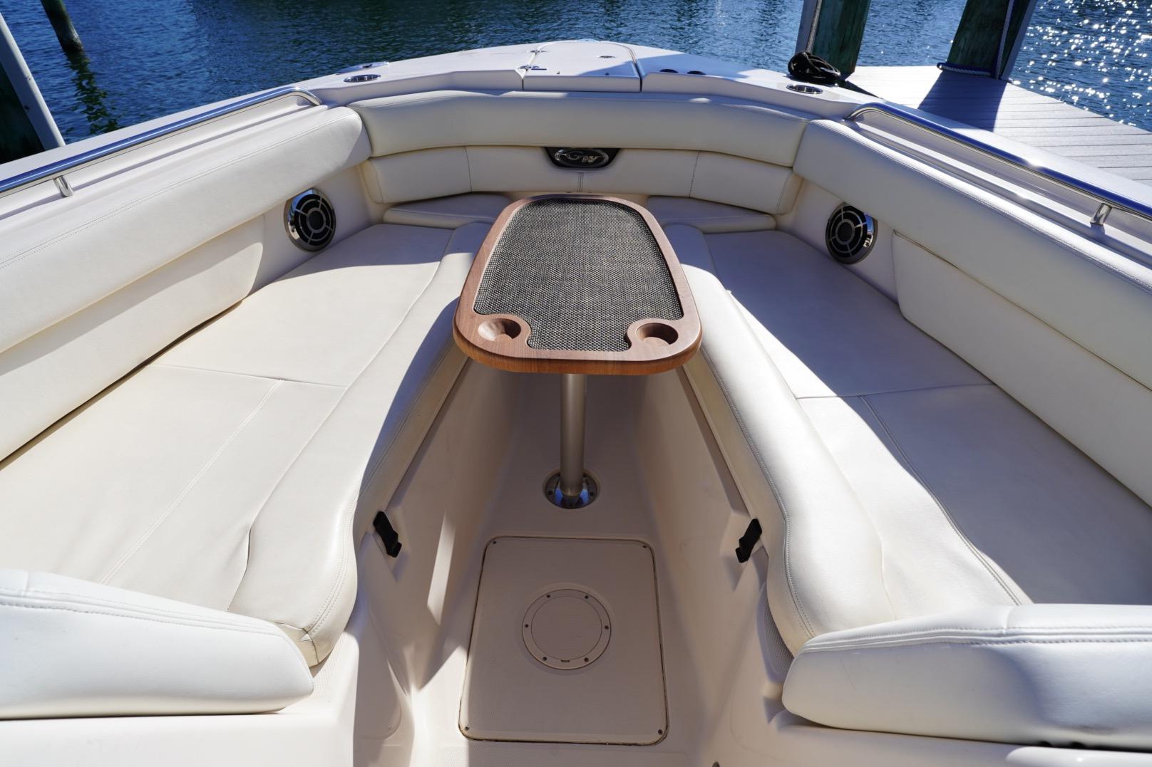Luxurious seating area on 2015 Grady-White Freedom 307 boat with table.