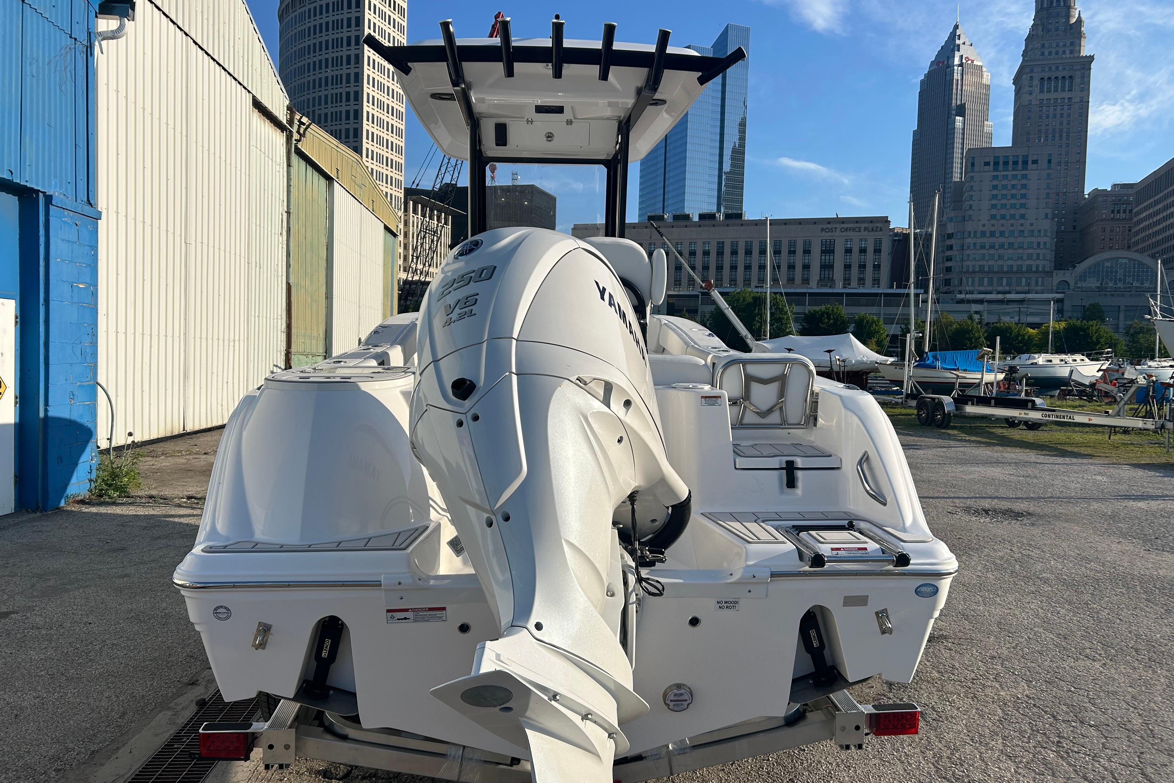 2026 Sea Fox 248 Commander boat with Yamaha V6 engine, docked near urban skyline.