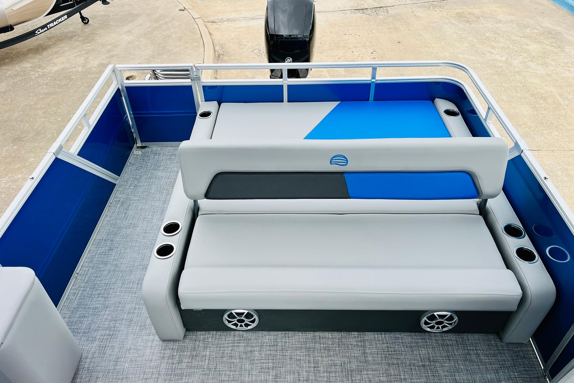 2026 Sun Tracker Party Barge 22 RF DLX interior with blue and gray seating.