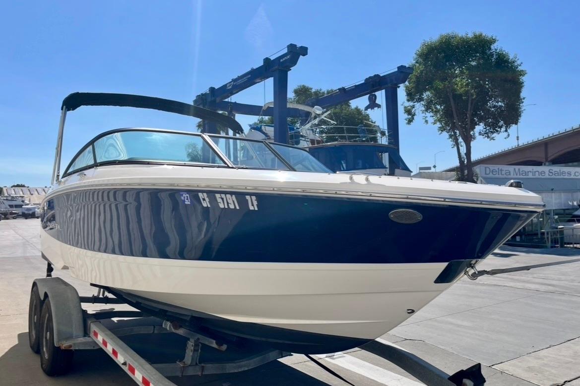 2025 Regal LX2 boat on trailer at marina, sunny day.