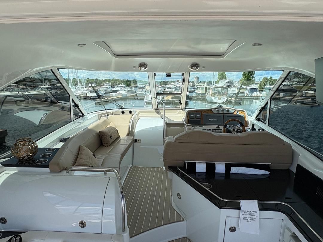 The image shows the cockpit of a 2011 Formula 45 yacht with beige seating and a helm station.