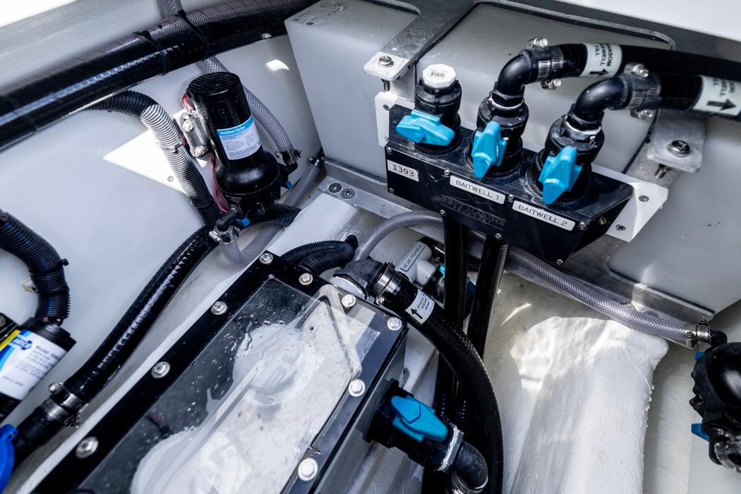 Engine compartment of 2026 Invincible 33 Catamaran, showcasing advanced plumbing and wiring systems.
