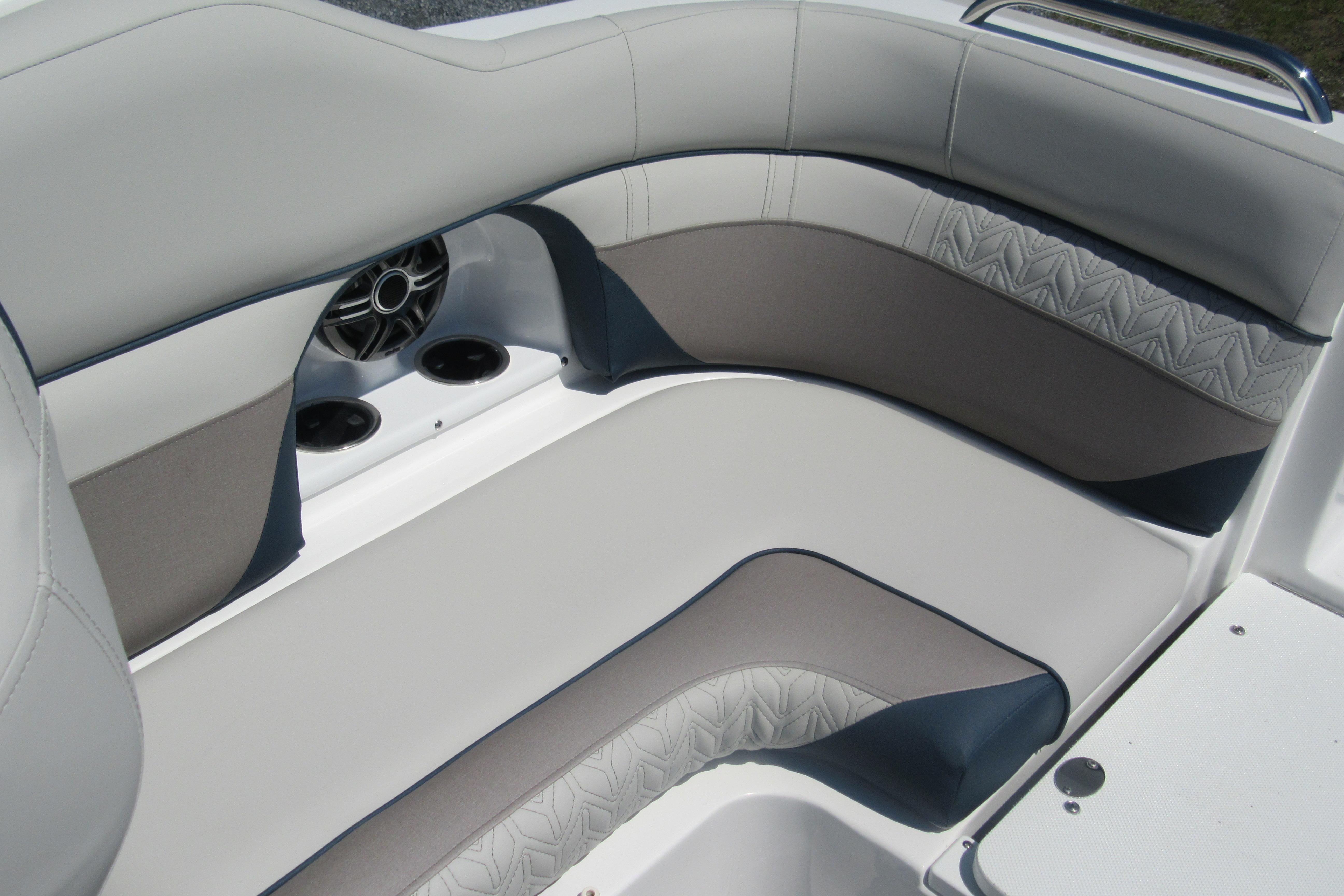 2027 Hurricane SunDeck 2486 OB boat interior with cushioned seating and speaker system.