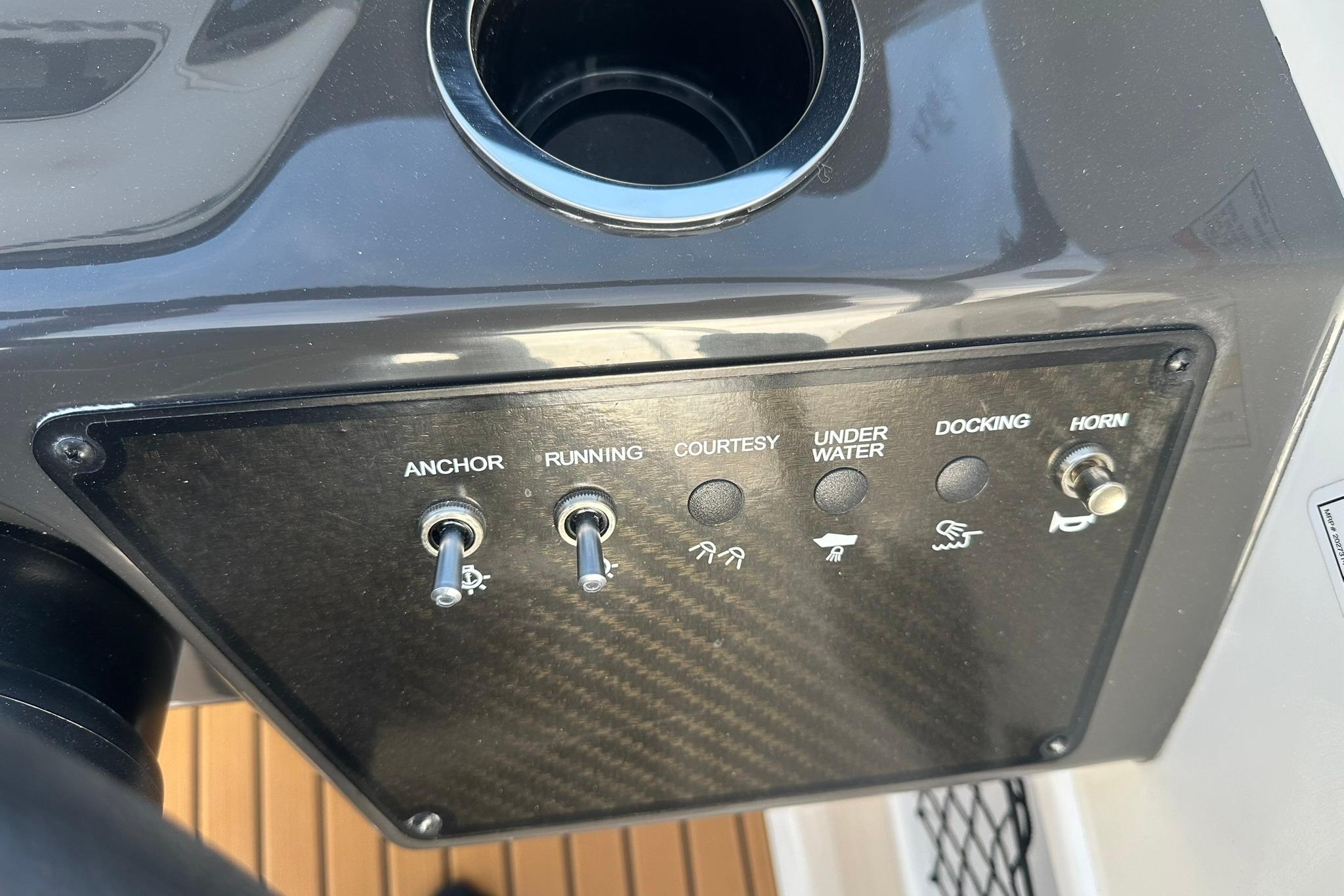 Control panel of 2026 Bayliner VR6 Bowrider OB with switches for anchor, running, and horn.