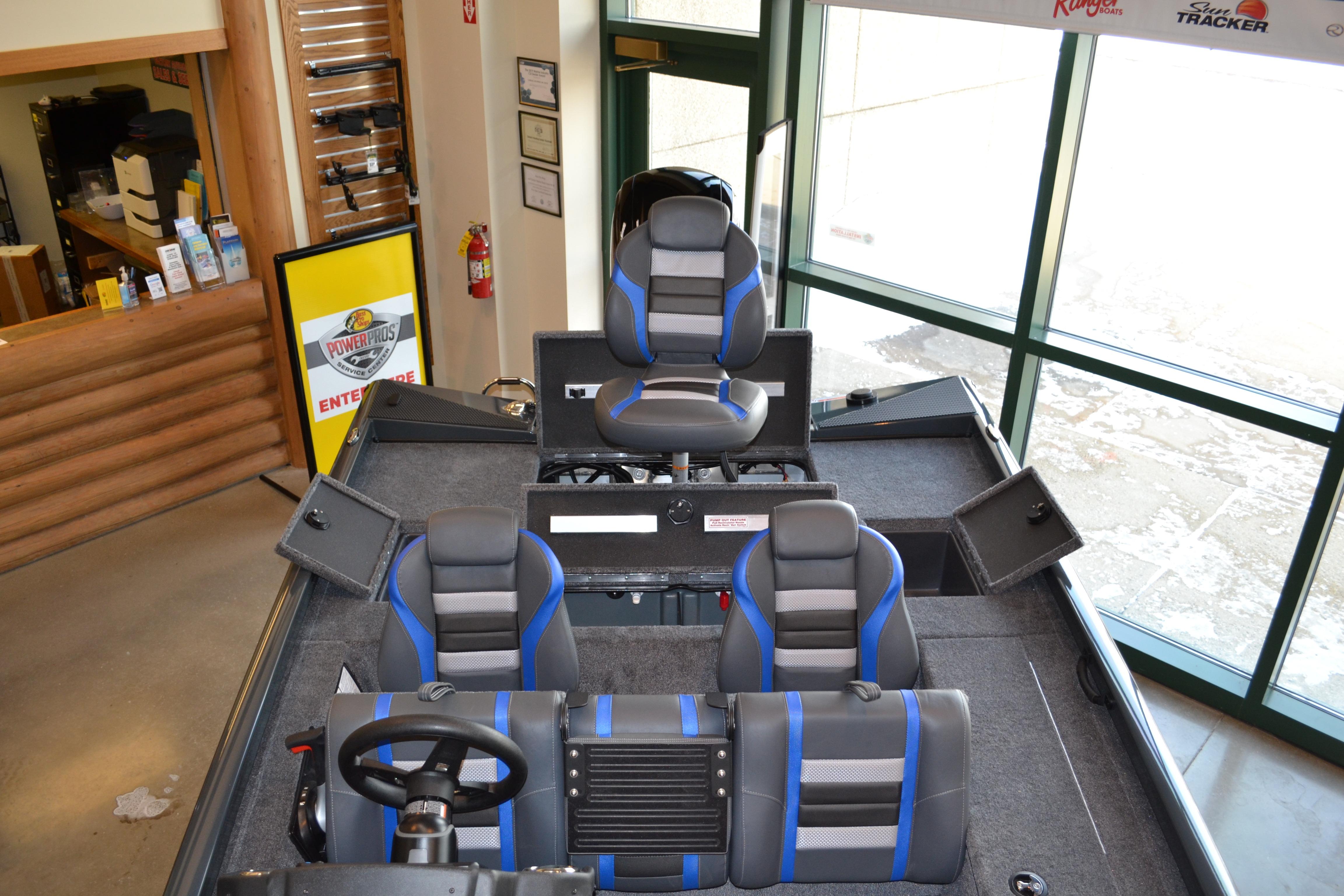 2026 Ranger RT178C boat interior with blue-accented seats and steering wheel in showroom.