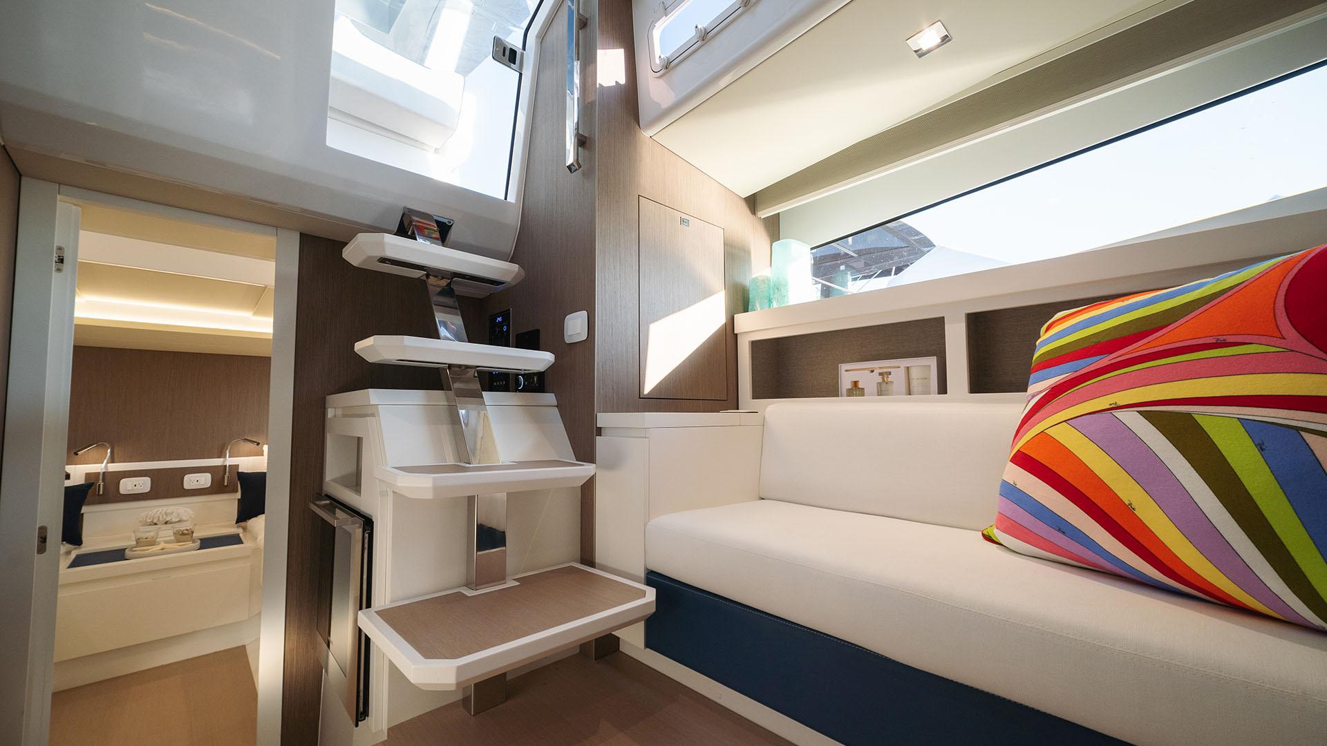 Interior of 2025 Fiart 43 Seawalker yacht with modern design and colorful pillow.