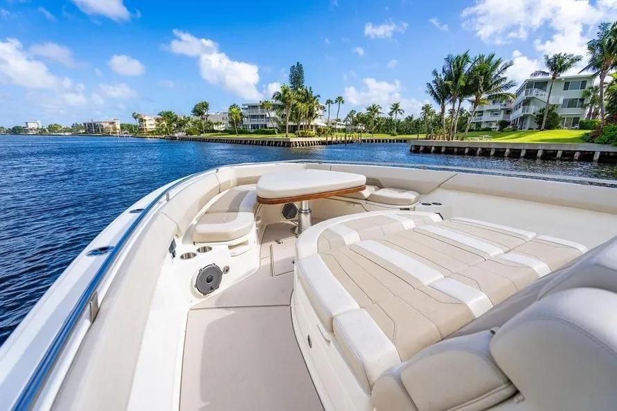 2022 Boston Whaler 420 Outrage boat interior with luxurious seating and scenic waterfront view.