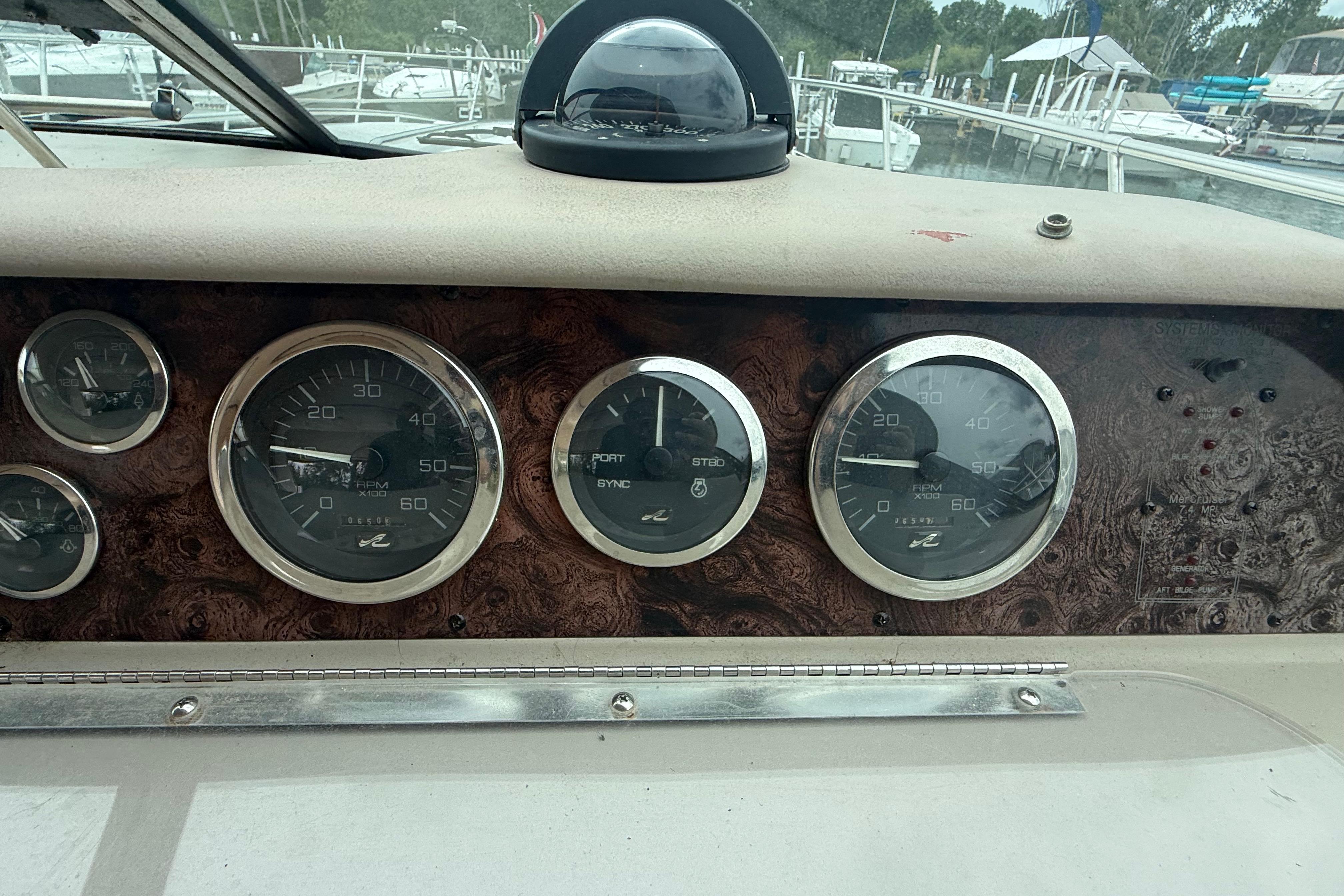 Dashboard of a 1998 Sea Ray Sundancer 400 with gauges and compass.