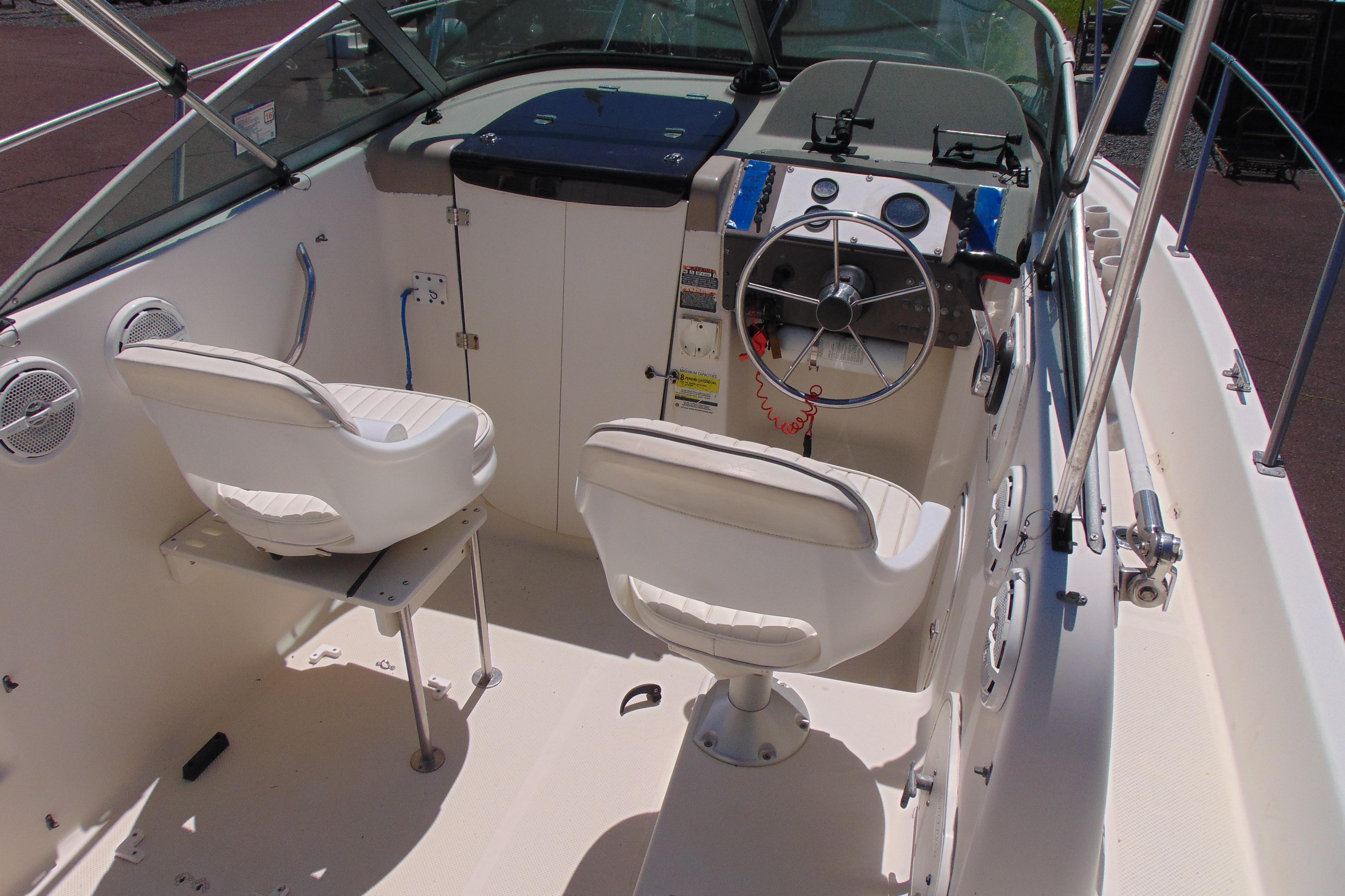2002 Trophy Walkaround boat interior with steering wheel and seating.