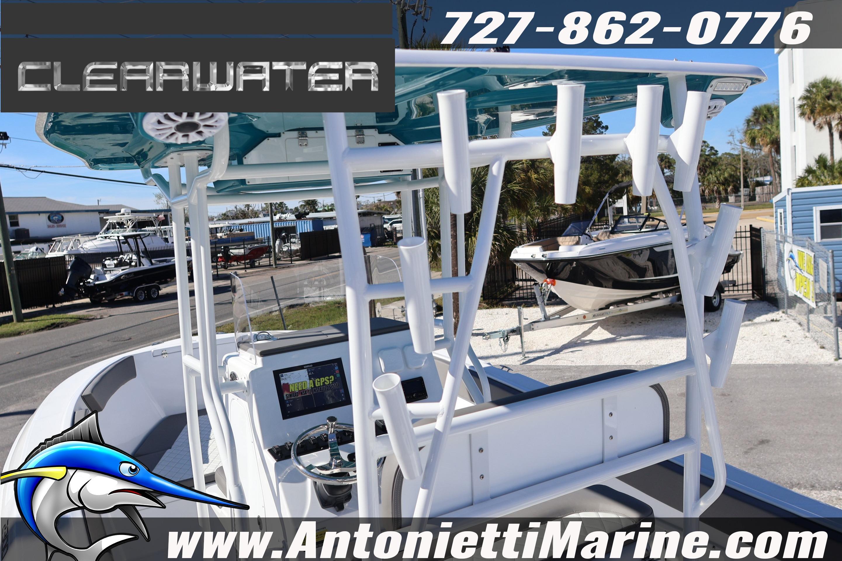 2026 Clearwater 2300 boat at Antonietti Marine dealership, featuring rod holders and GPS system.