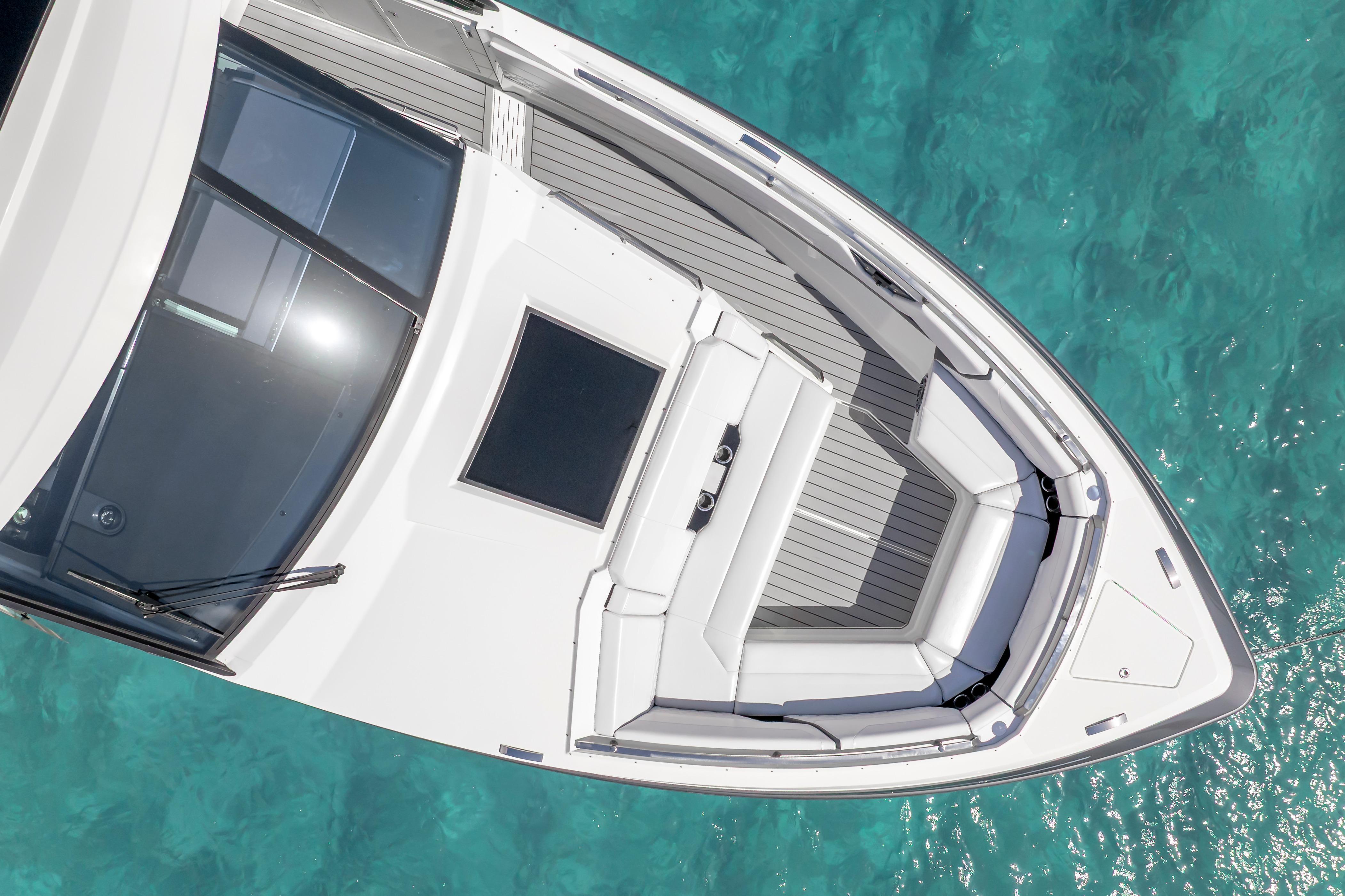 2022 Formula 500 Super Sport Crossover boat on clear turquoise water, top view.