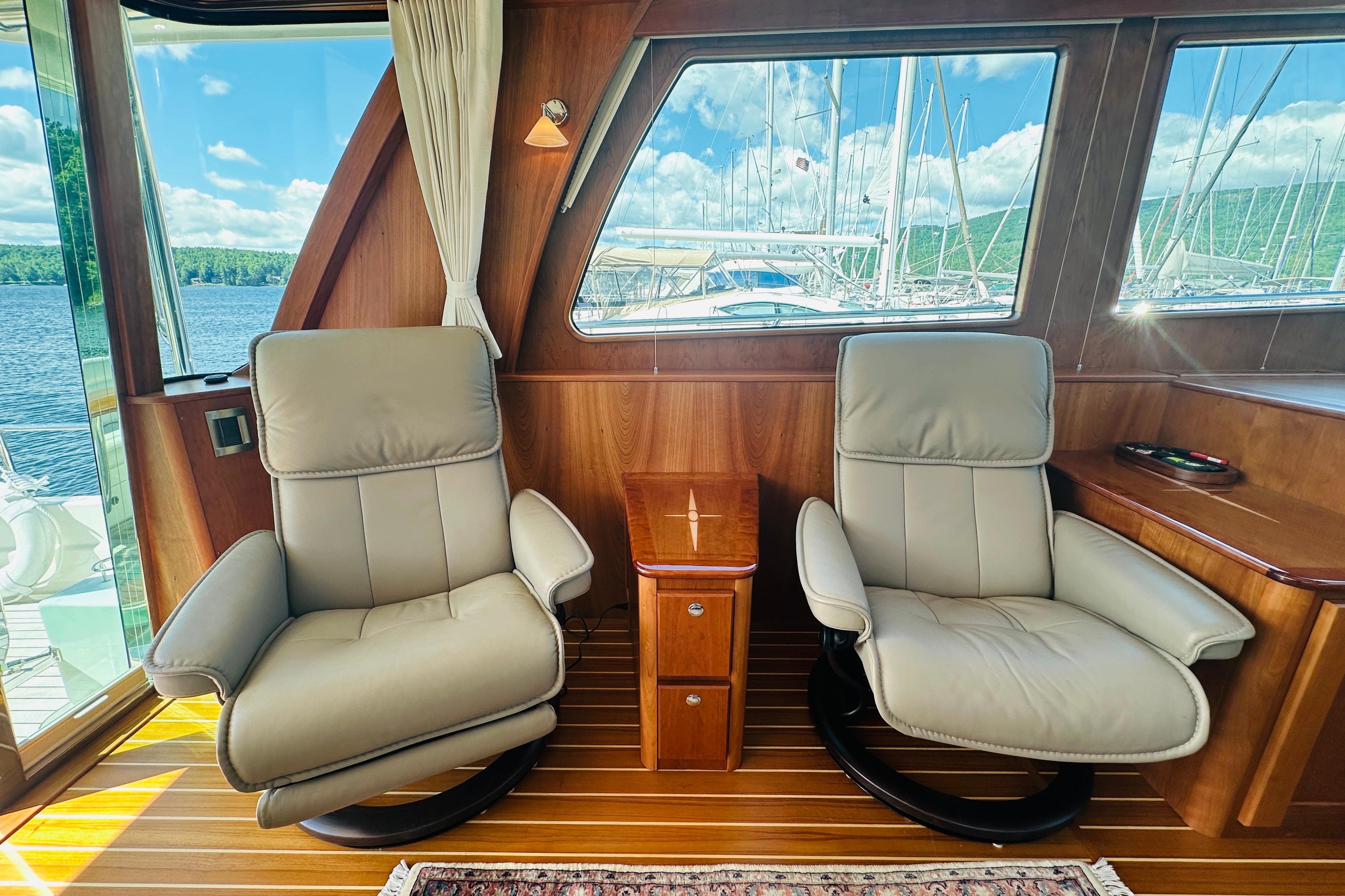 Luxurious interior of 2025 Sabre 48 Salon Express yacht with plush seating and scenic views.