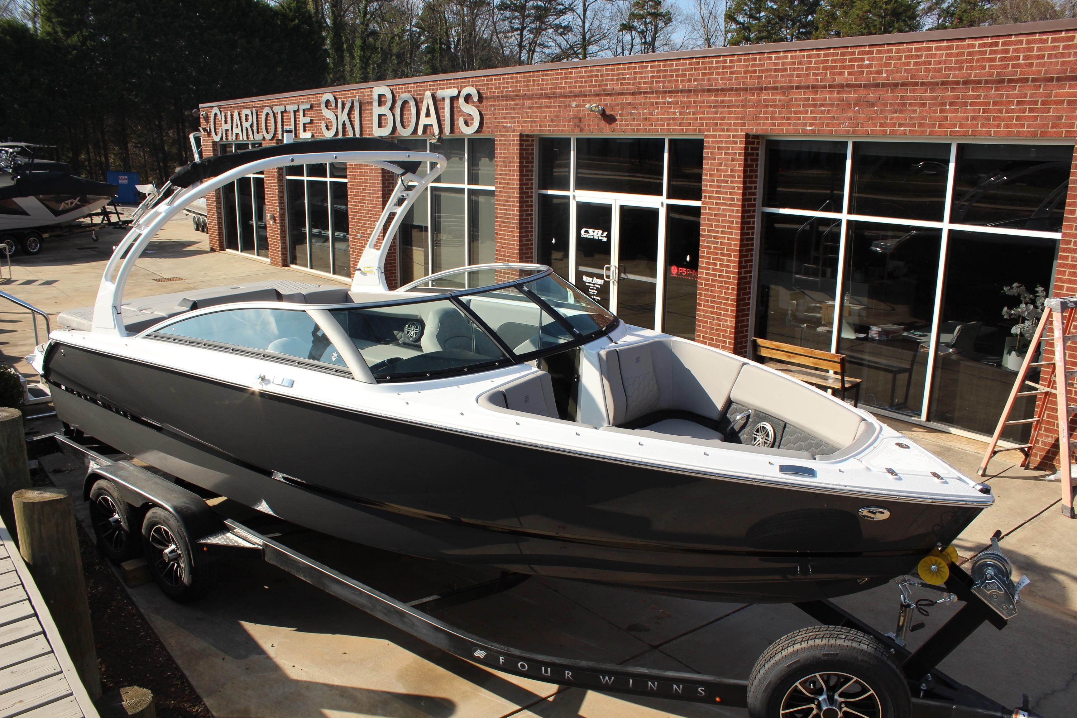 2026 Four Winns H4 boat on trailer at Charlotte Ski Boats dealership.
