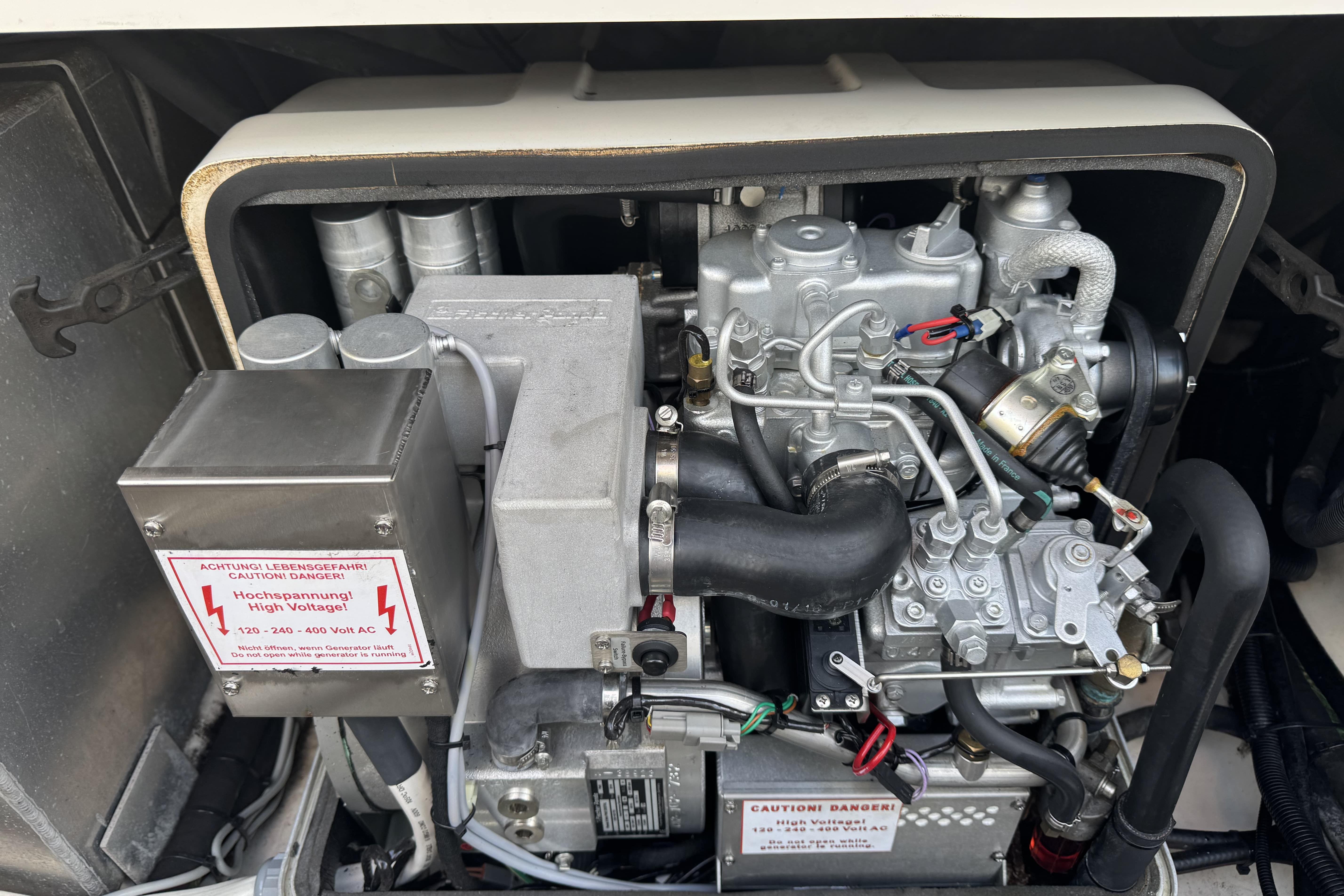 Engine compartment of a 2017 Boston Whaler 370 Outrage with high voltage warning.
