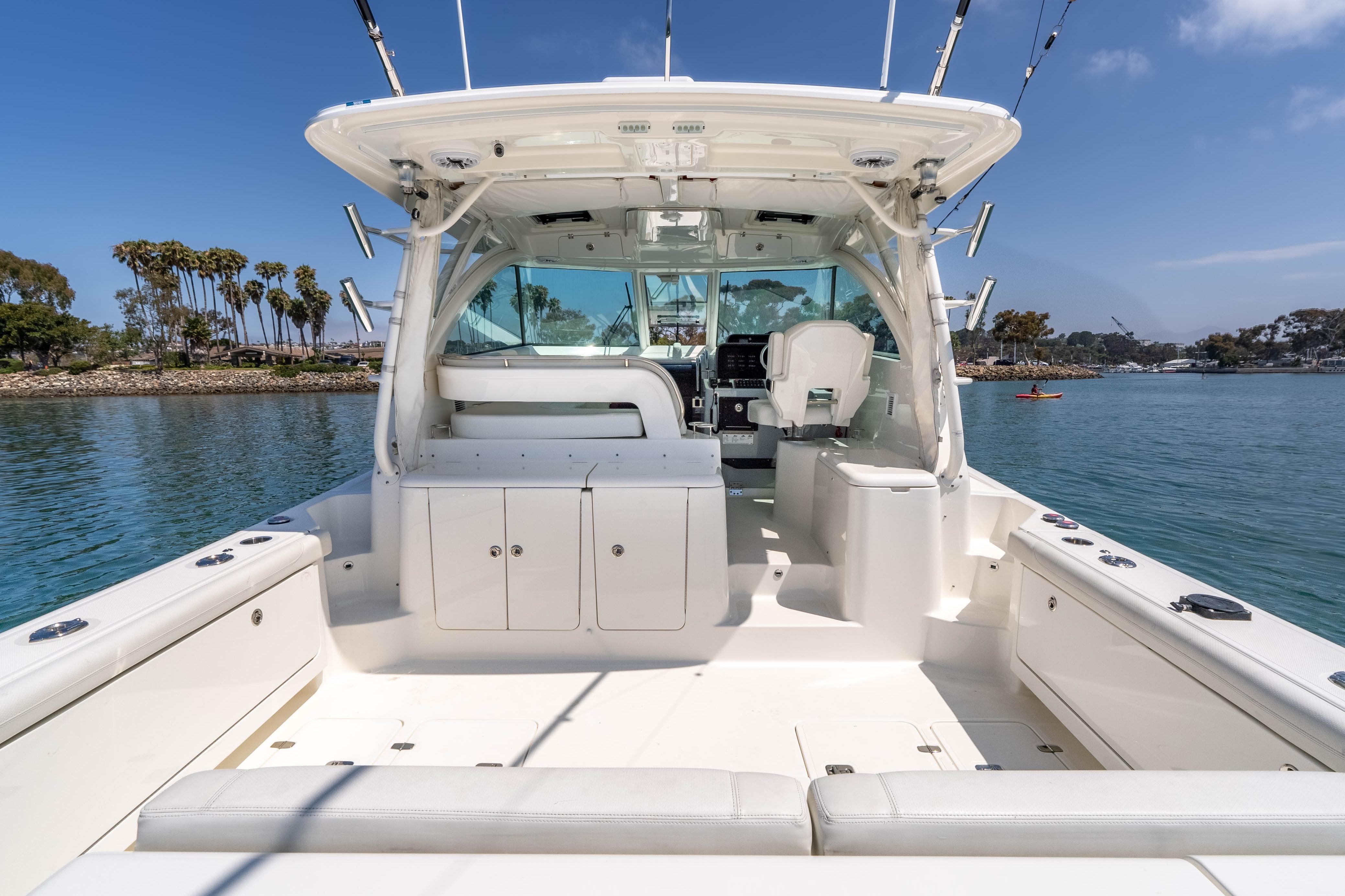 2022 Pursuit OS 385 Offshore boat interior with seating, ocean view, and clear sky.
