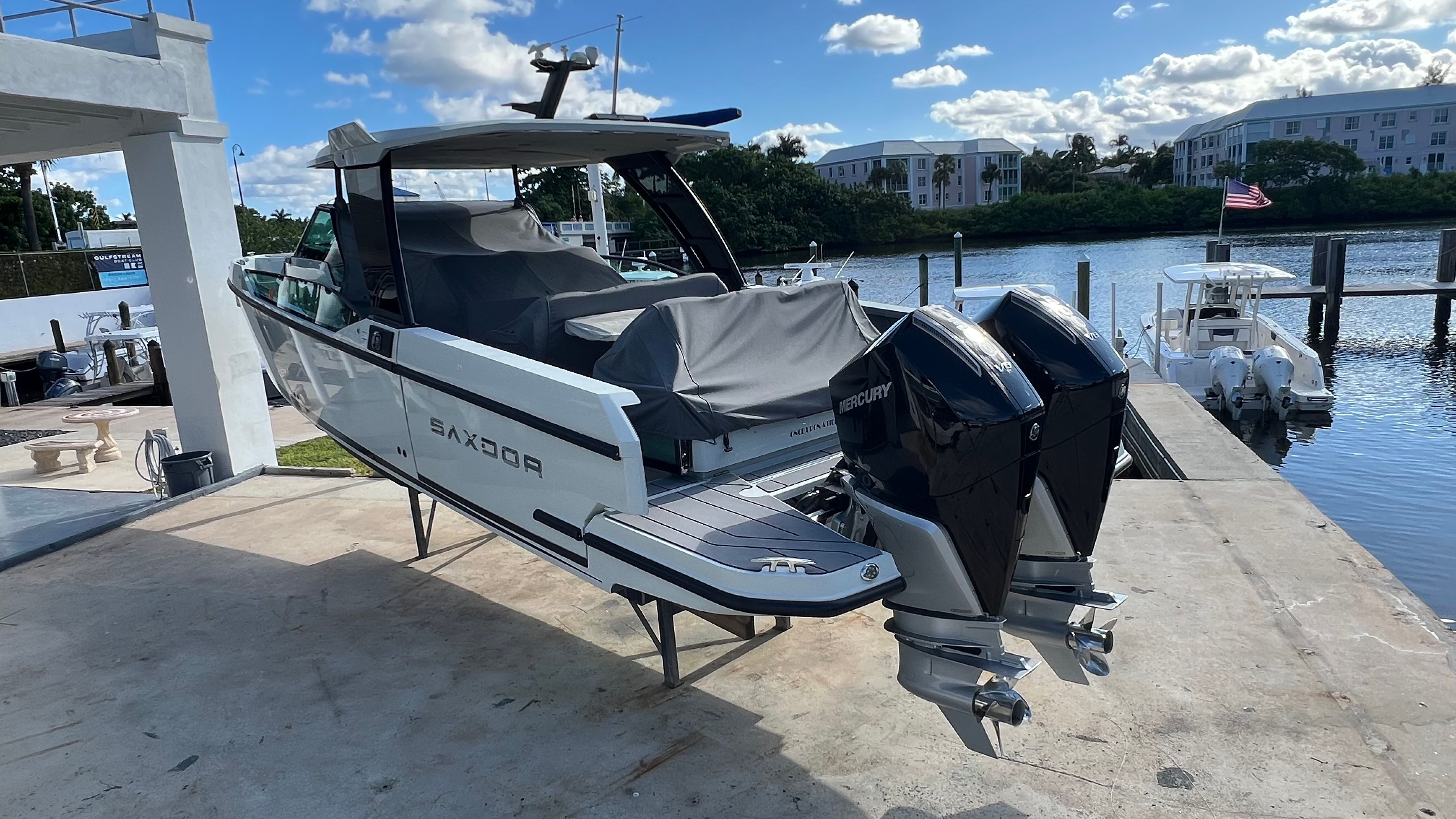 2024 Saxdor 320 GTO motorboat docked with twin engines.