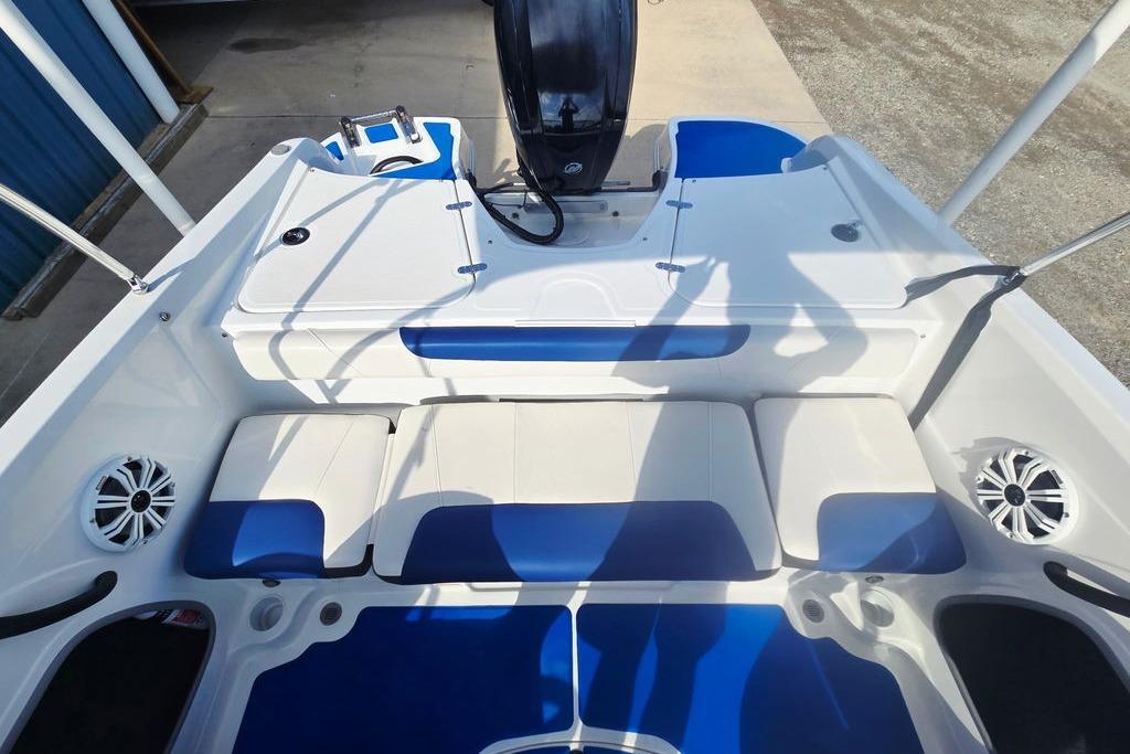 2018 Tahoe 450 TS boat interior with blue and white seating and speakers.