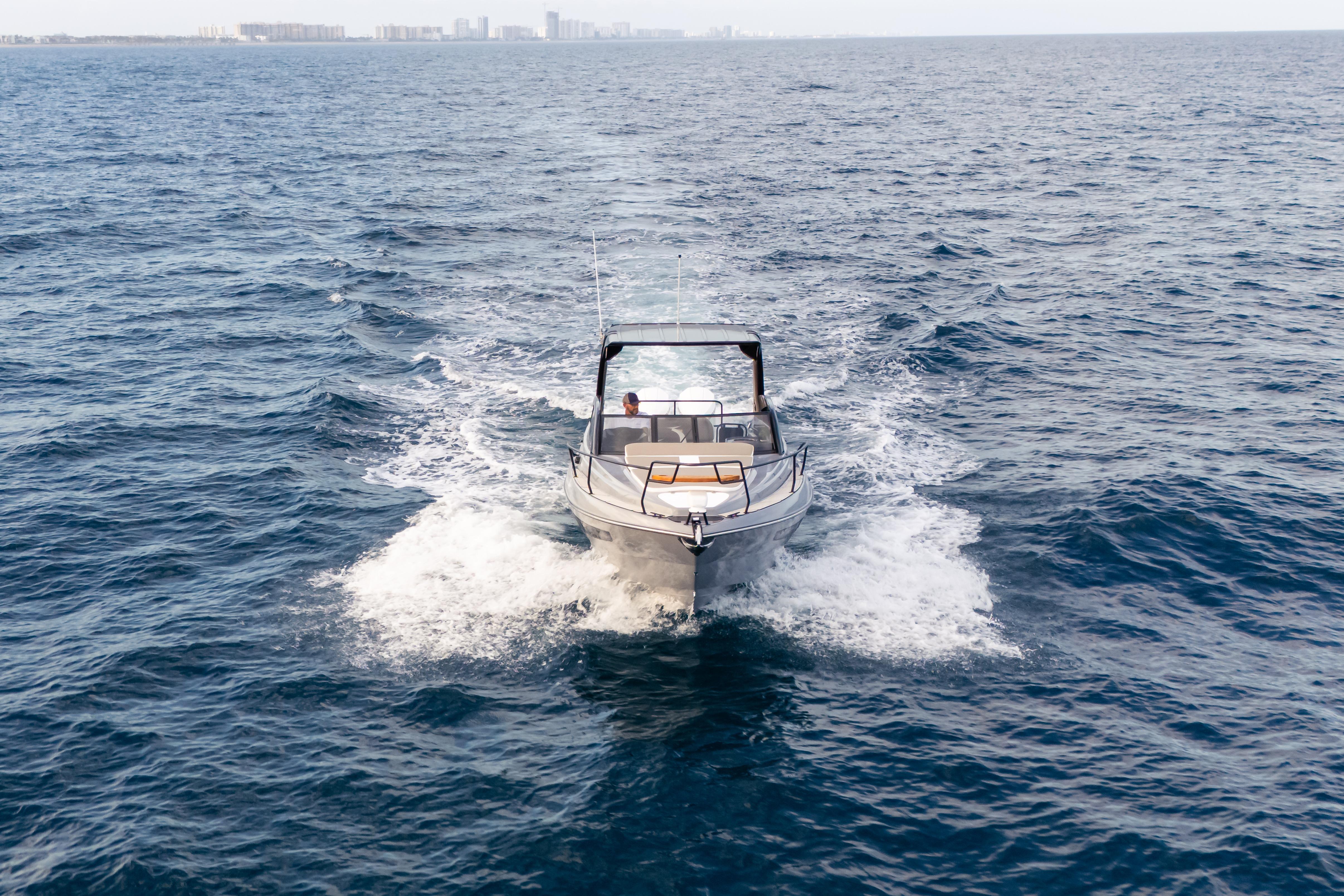 Modern Hanover 305 boat cruising on open sea, 2026 model.