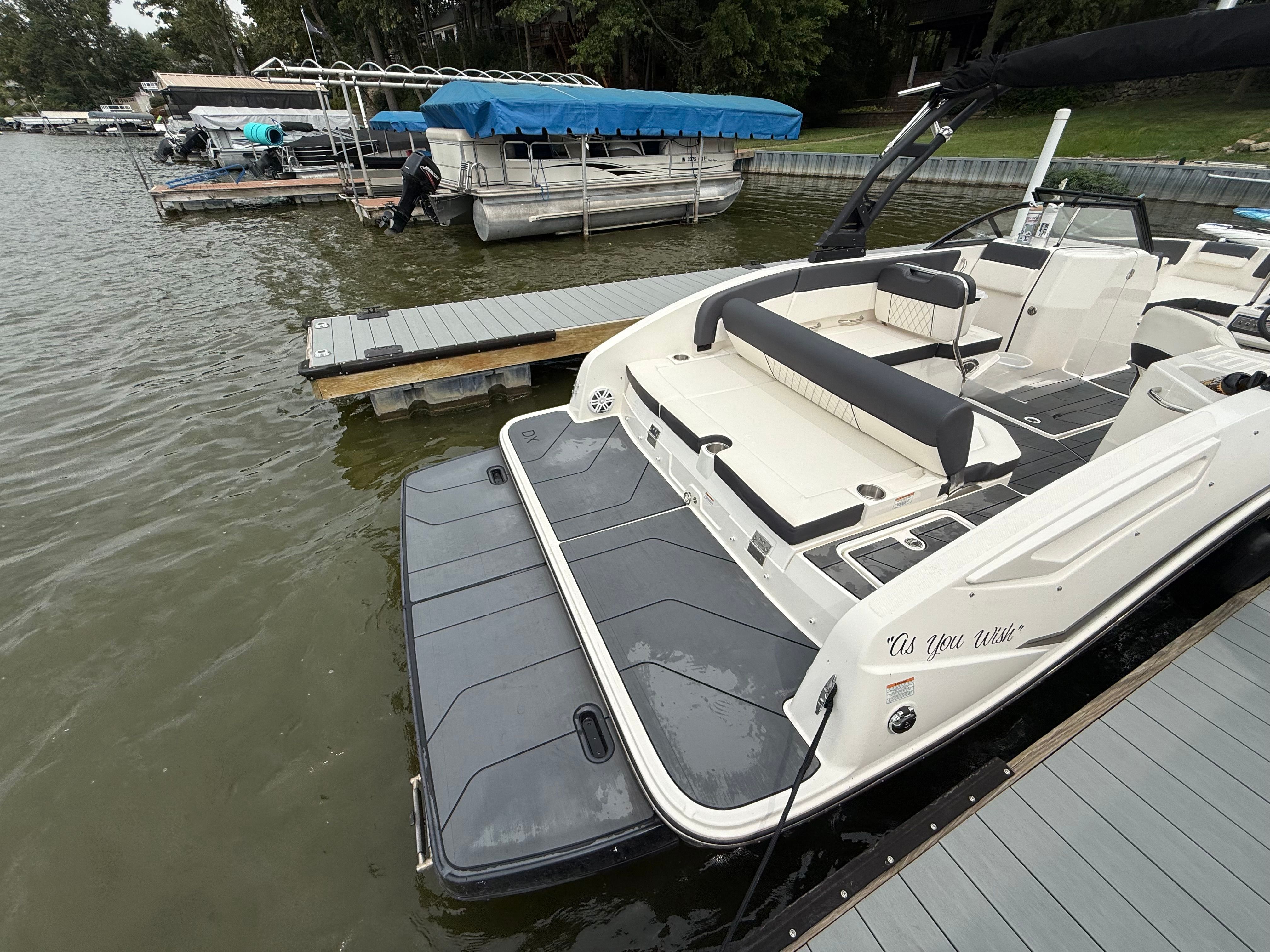 2022 Bayliner DX 2250 boat docked at a marina with spacious seating.