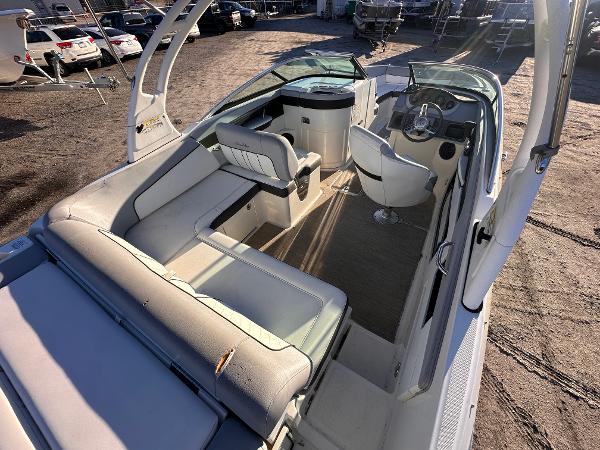 2016 Sea Ray 240 Sundeck interior with seating and helm, parked outdoors.