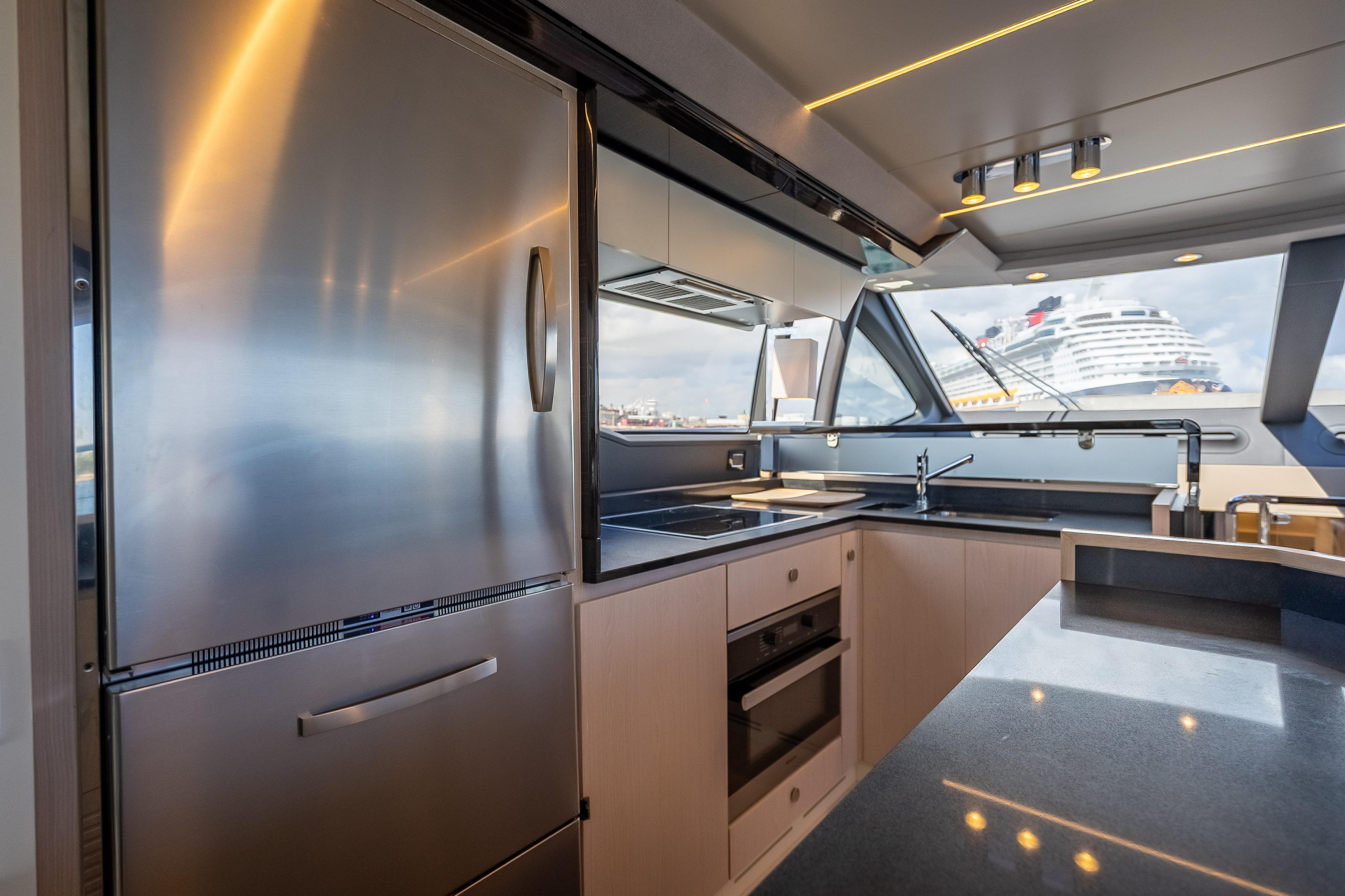 Luxurious kitchen interior of 2019 Azimut 66 yacht with modern appliances and ocean view.
