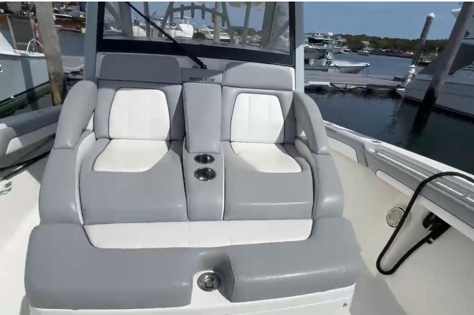 2019 Regulator 41 boat with comfortable gray and white seating at a marina.