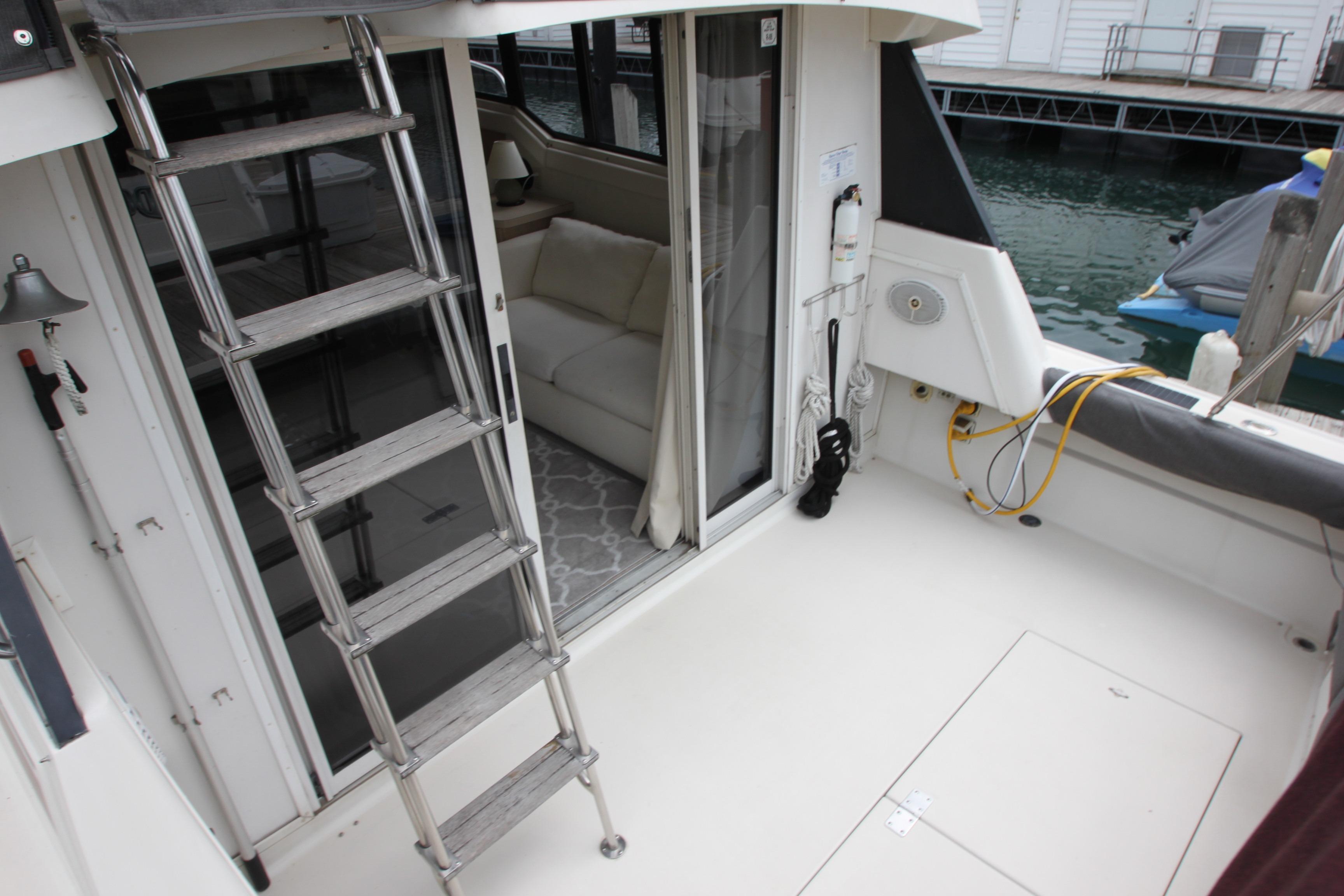 1990 Silverton 34 Convertible boat interior with ladder and dock view.