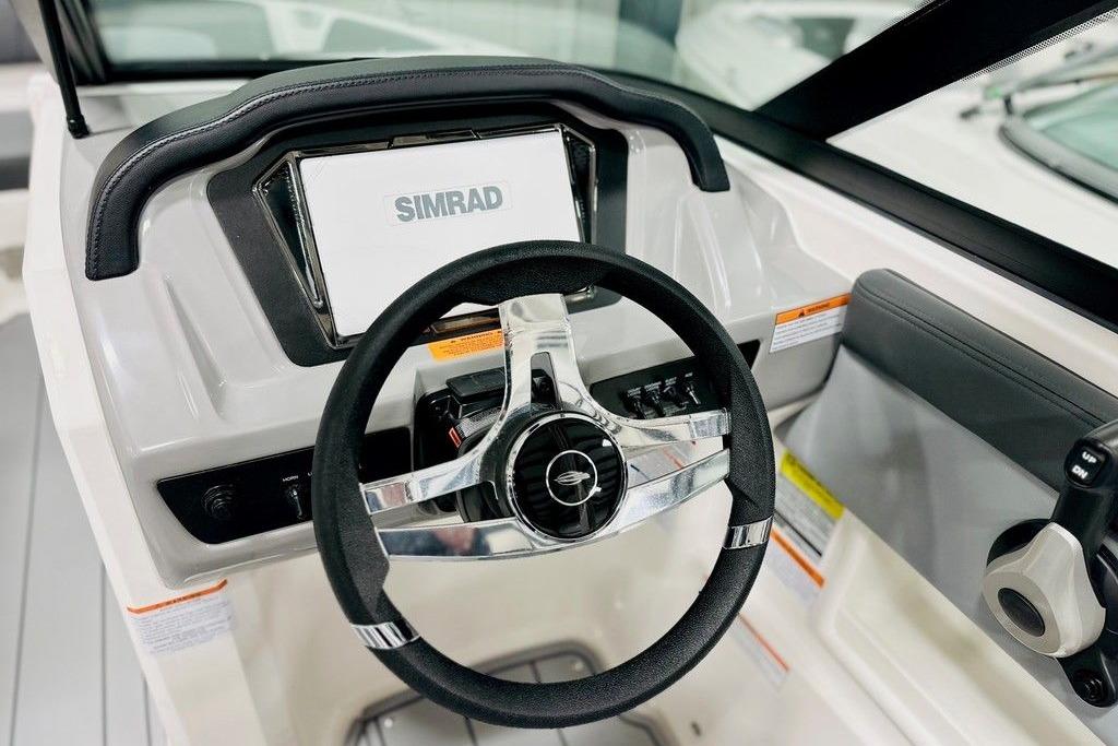 2025 Chaparral 23 SSi OB boat dashboard with Simrad display and steering wheel.