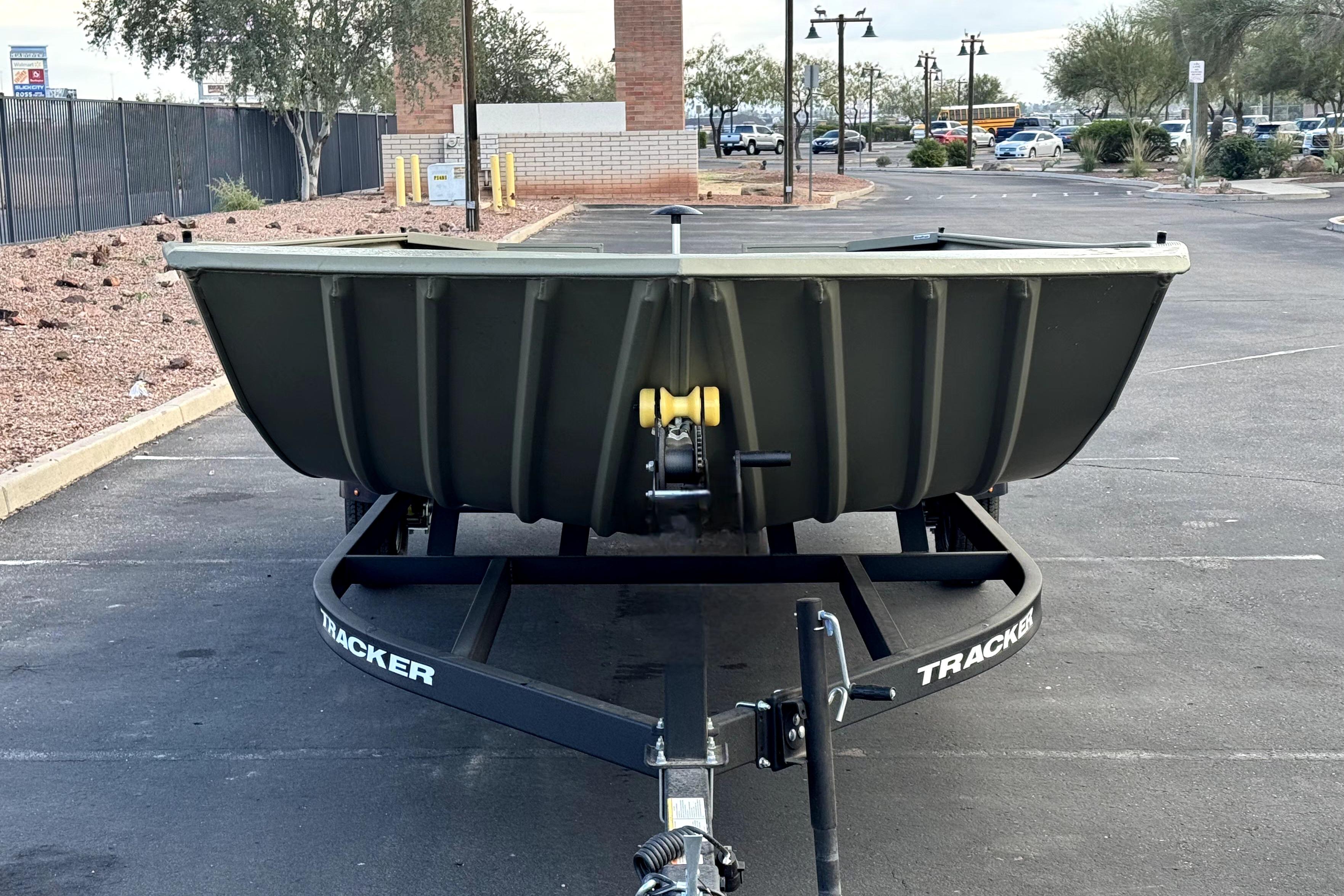 2026 Tracker Grizzly 2072 Utility boat on trailer in parking lot.