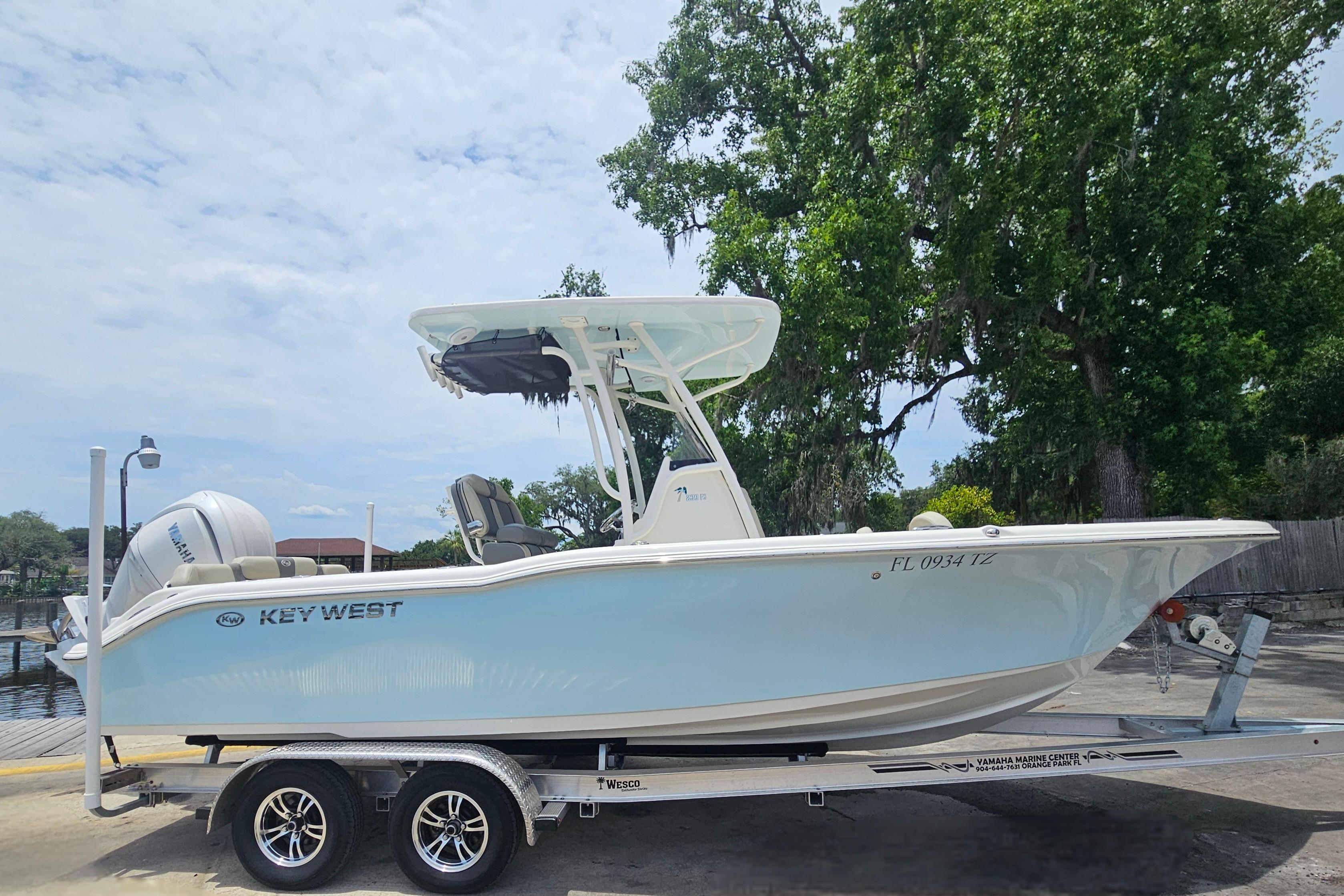 2025 Key West 239 FS boat on trailer, parked outdoors near trees.