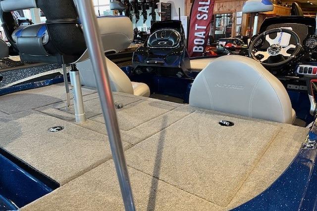 2026 Nitro Z17 boat interior with seating and dashboard, displayed at a boat sale event.