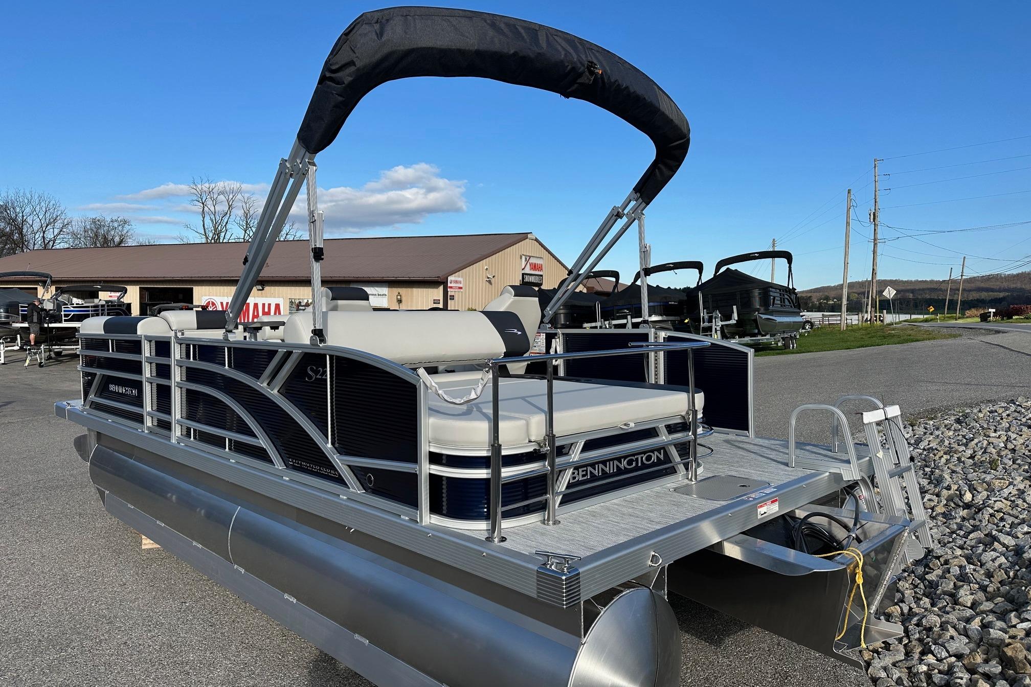 2026 Bennington 22 SSB SwingBack pontoon boat with Yamaha 90 Hp engine, parked outdoors.