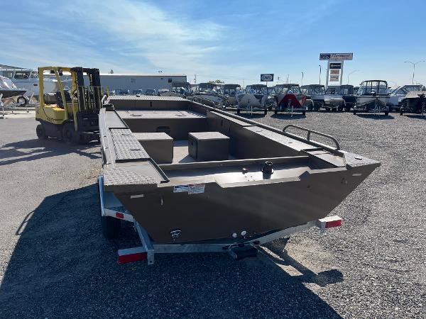 2024 Smoker Craft 1660 Sportsman Pro boat on trailer in outdoor lot.